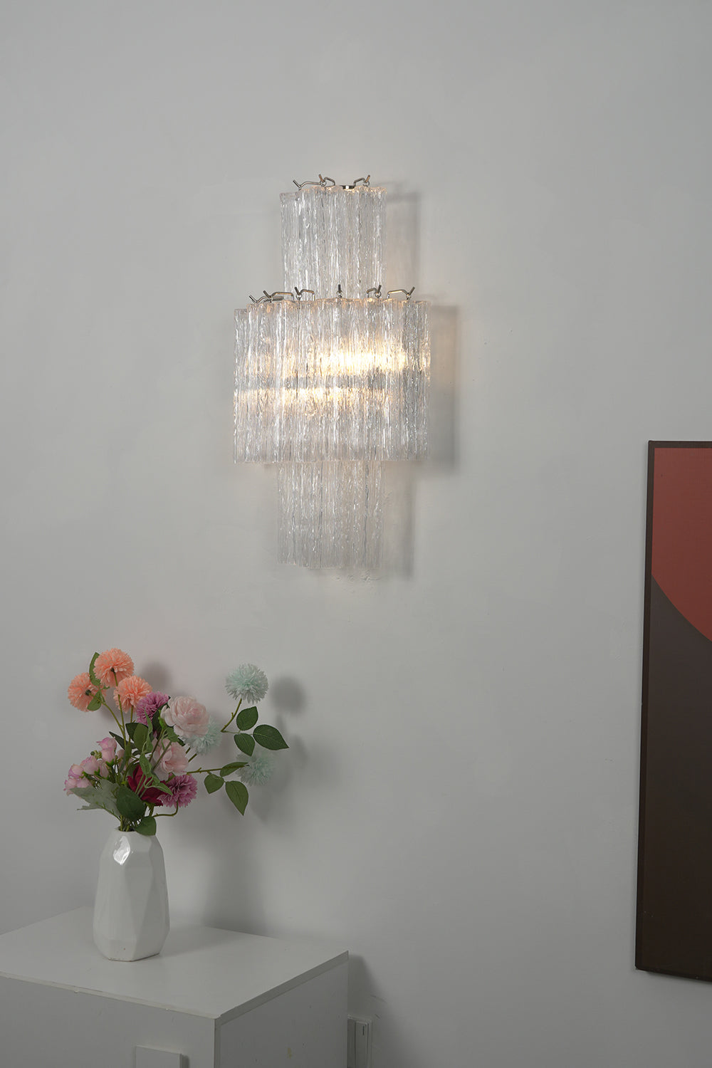 Lit glacier glass wall light | Metal, Glass | Close-up showing internal light source and texture | Samu Lamp