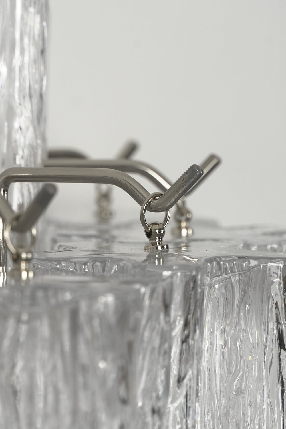 Detail of silver metal frame hook and glacier glass | Metal, Glass | Close-up shot showing construction details | Samu Lamp