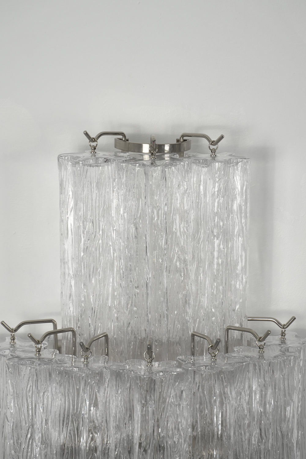 Bottom view detail of glacier modern tiered glass sconce | Metal, Glass | Showing multiple tiers from below | Samu Lamp