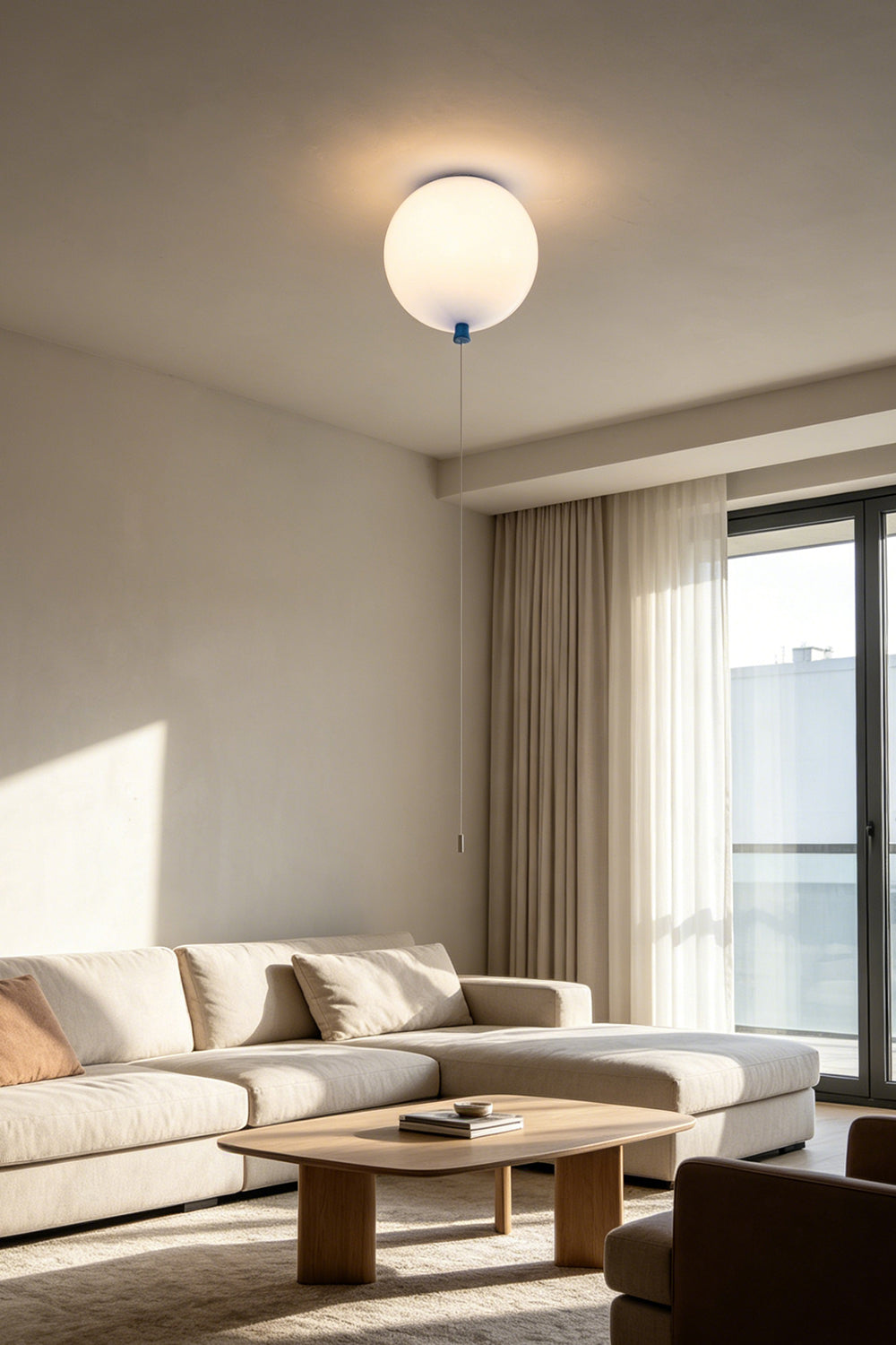 Glass Balloon Ceiling Light illuminating a modern living room with a light and airy atmosphere.