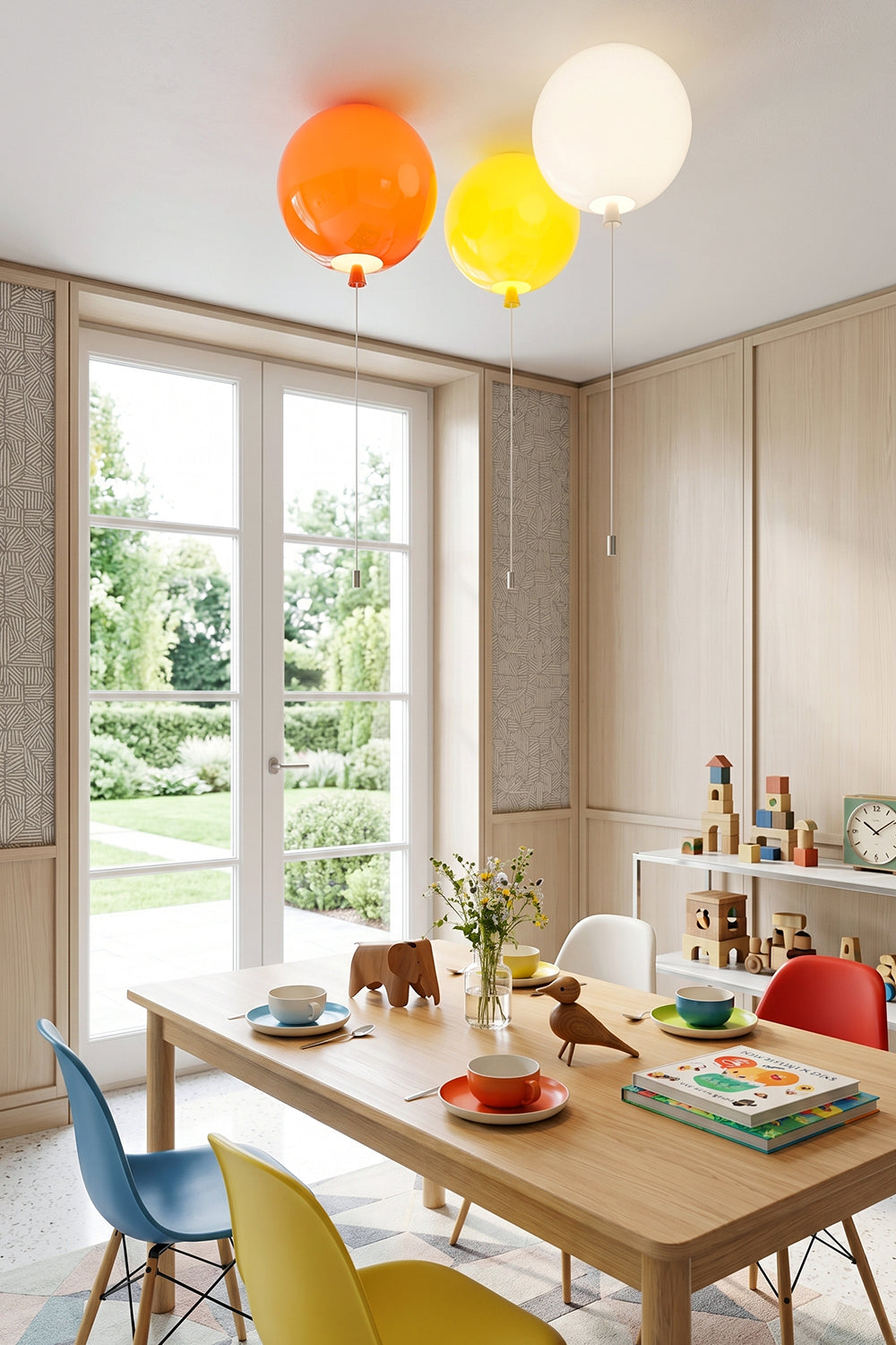 Colorful Glass Balloon Ceiling Light fixtures illuminating a modern dining room with wooden furniture and playful decor.