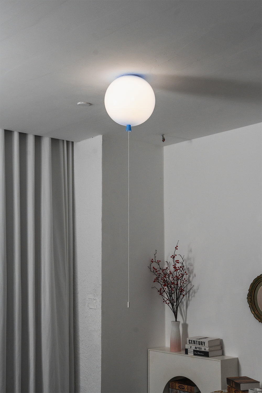 Glass Balloon Ceiling Light illuminating a modern room with playful minimalist design elements.