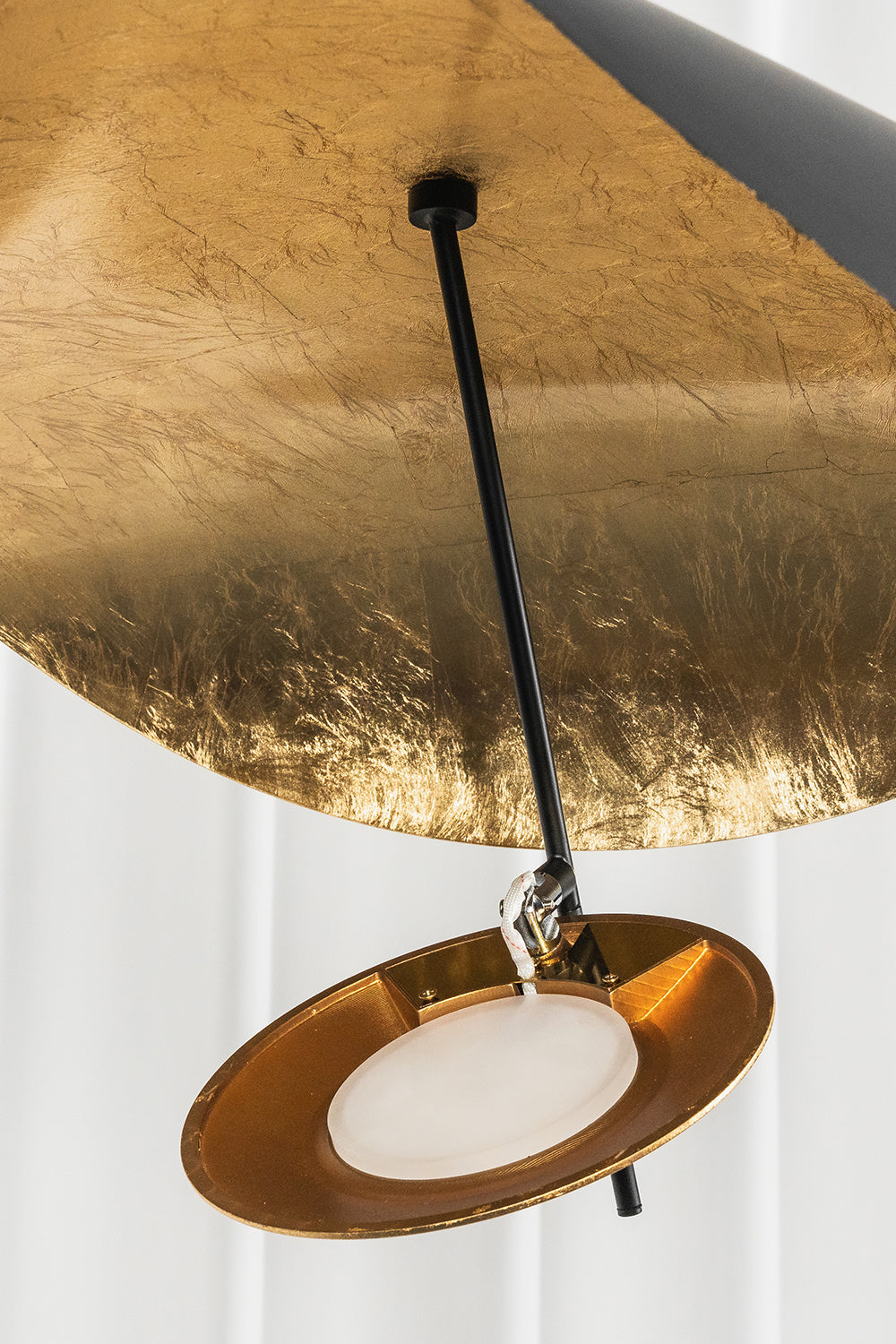 Gold-Tone Sculptural Ceiling Light showcasing its elegant gold and black finish, featuring a textured metal canopy.