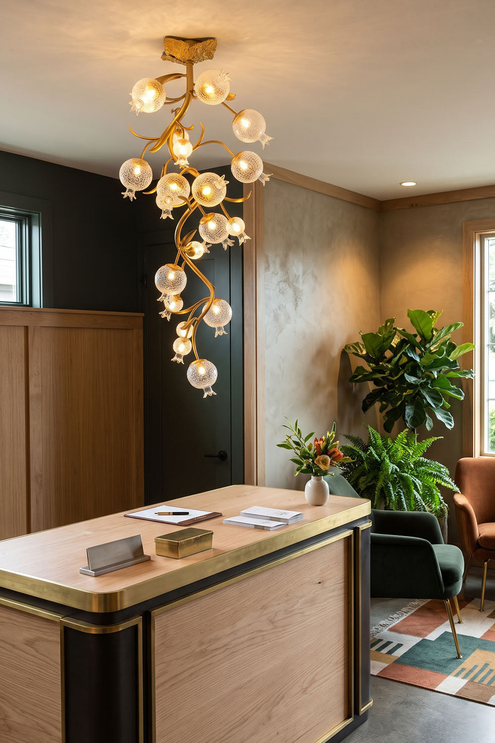 Grenaline Vine Chandelier | Botanical Brass and Glass | Hanging above a wooden island with indoor plants | Samu Lamp