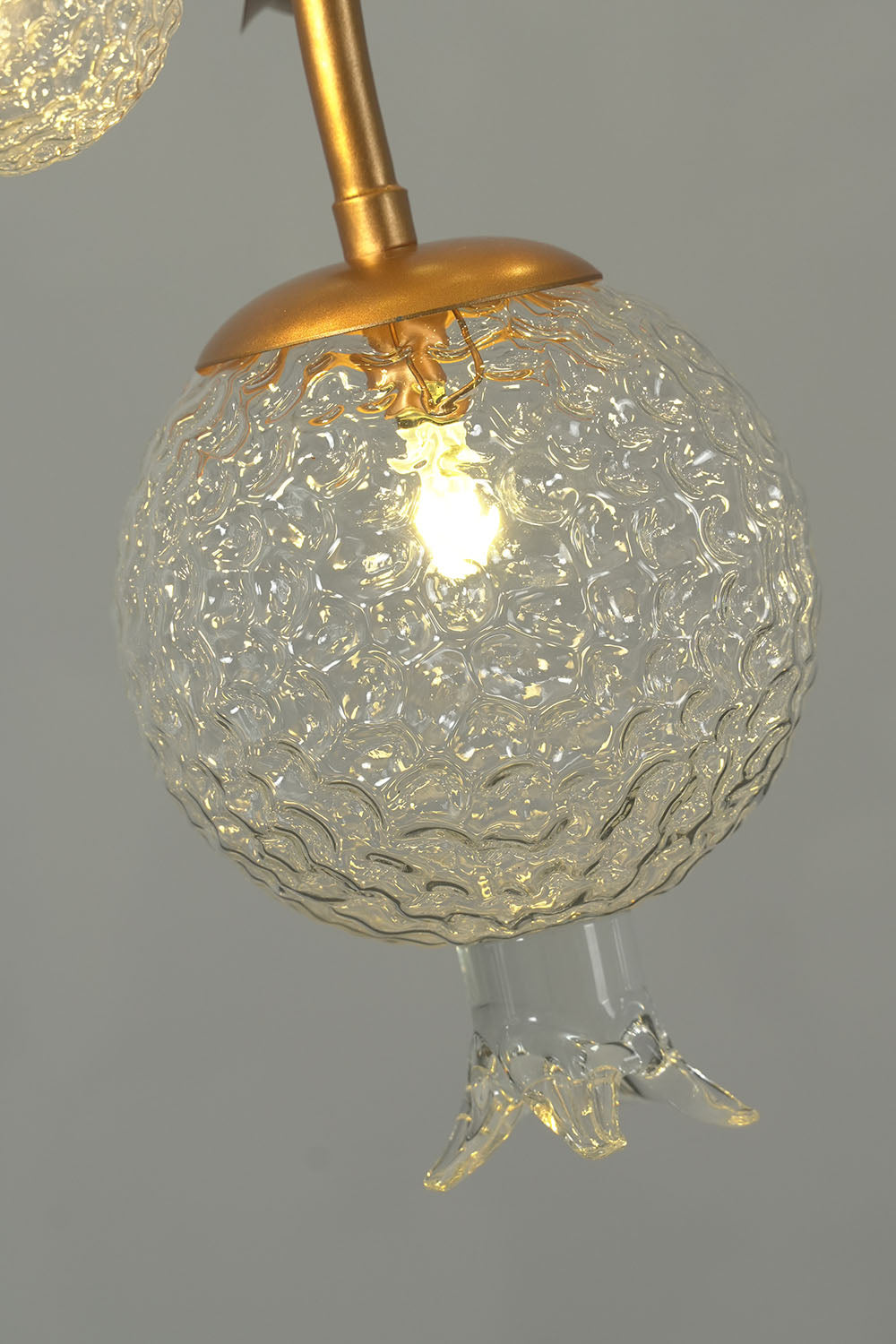 Grenaline Vine Chandelier | Crackle Glass and Brass | Lit close-up of warm light through textured glass shade | Samu Lamp
