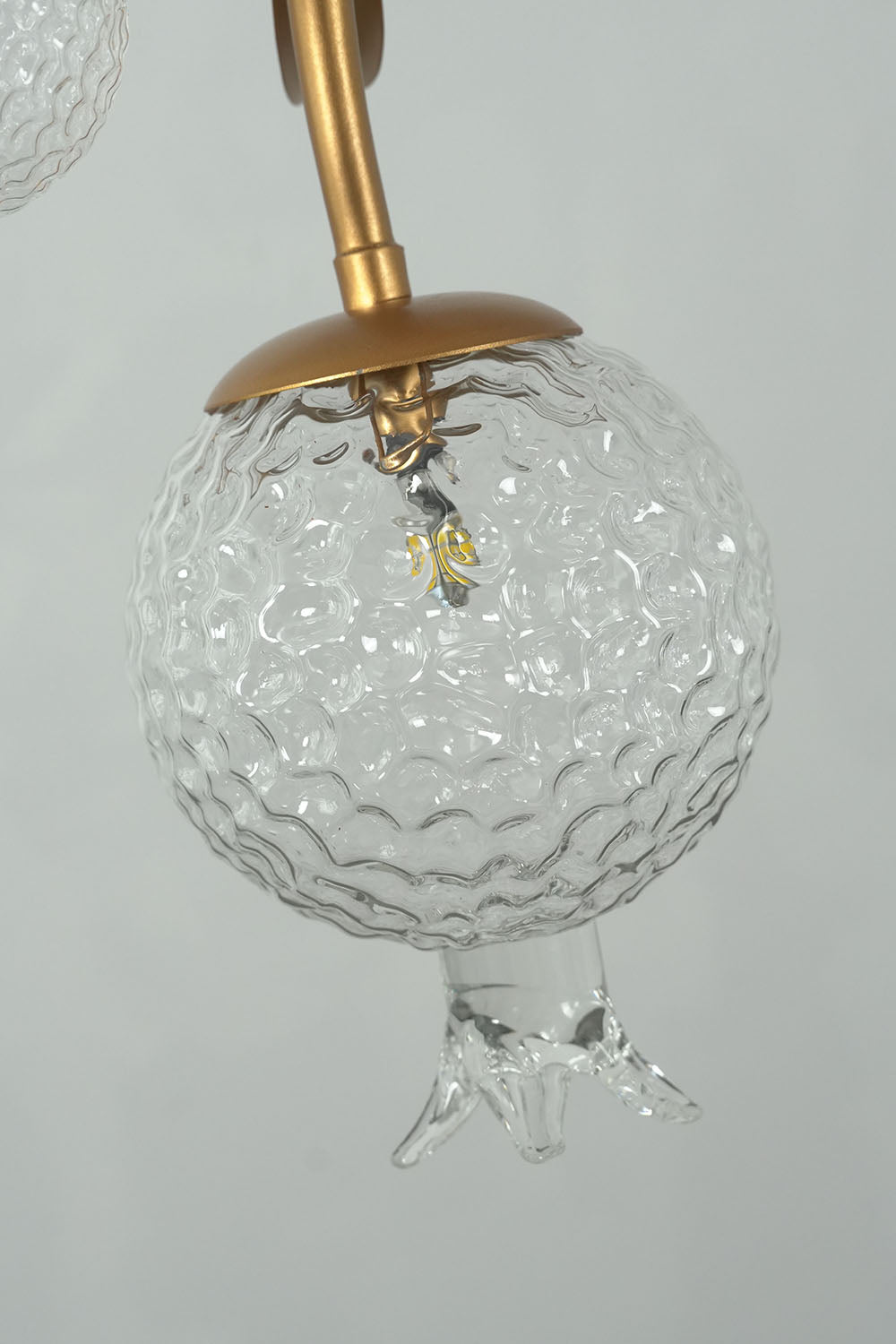 Grenaline Vine Chandelier | Crackle Glass and Brass | Macro view of textured glass pomegranate globe and calyx | Samu Lamp