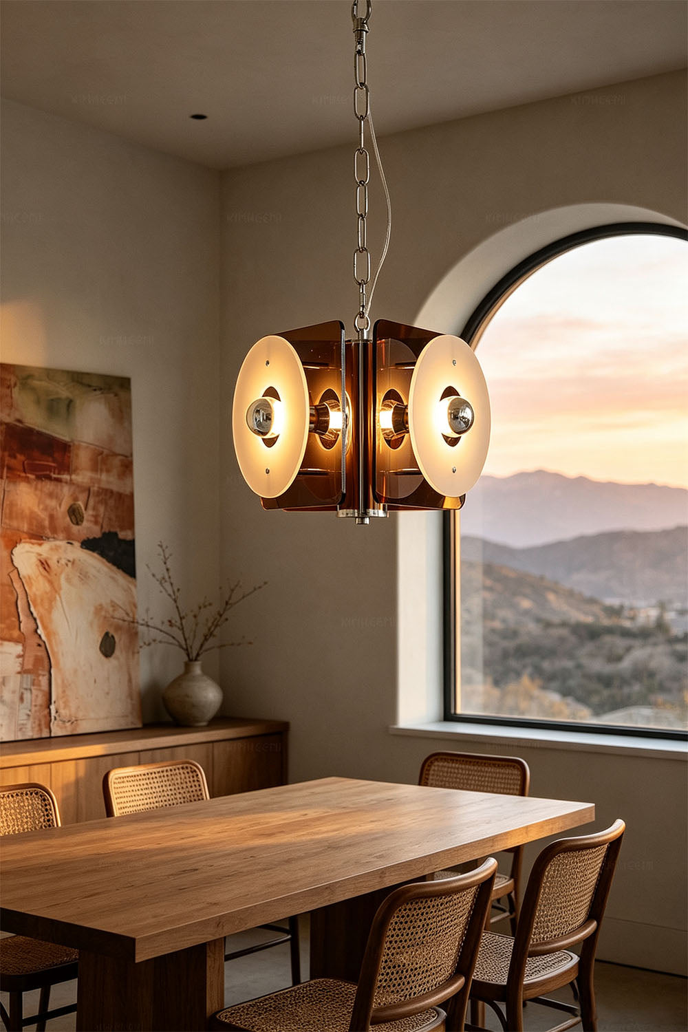 Harlan Faceted Drum Brass Pendant Light illuminating a dining room with sunset view and wooden furniture.