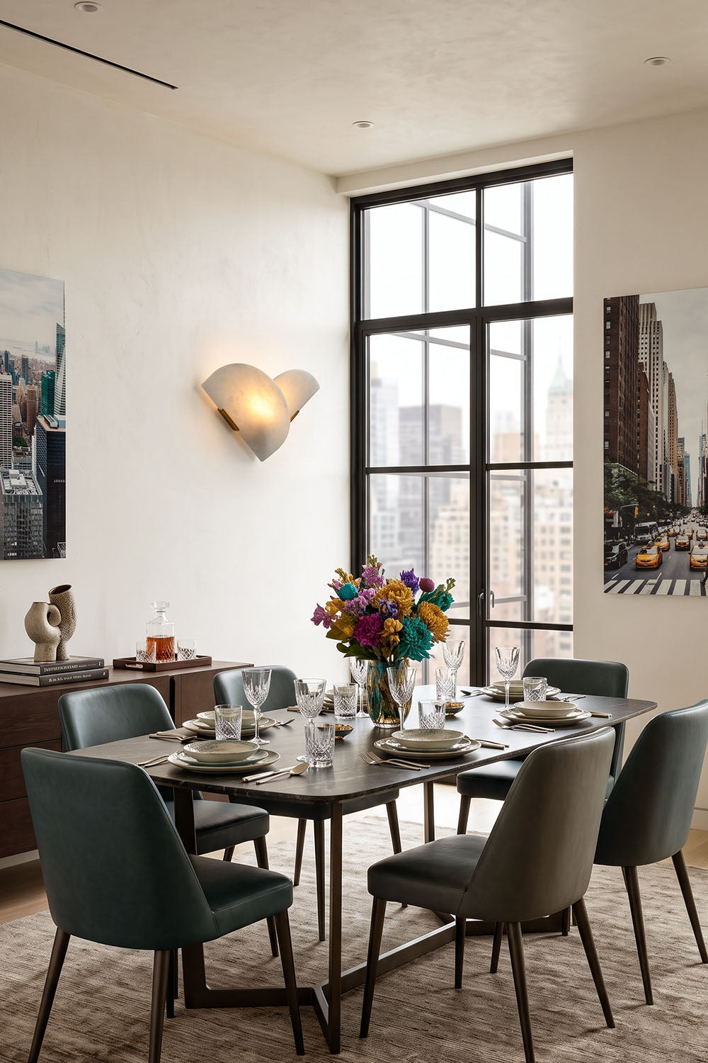 Hollis Angled Alabaster Wall Lamp | Natural Alabaster and Metal | Styled on a dining room wall near a table with green chairs | Samu Lamp