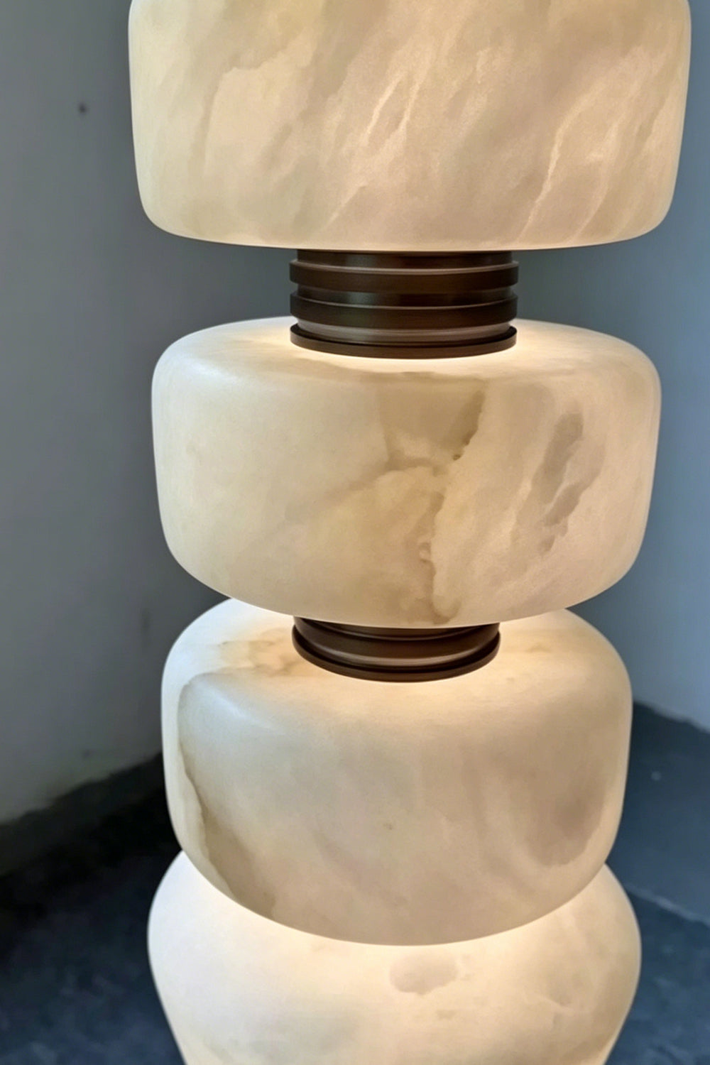 Alabaster and Brass Detail | Alabaster, Brass | Close-up of unlit stacked stone geometric shapes and metal rings | Samu Lamp