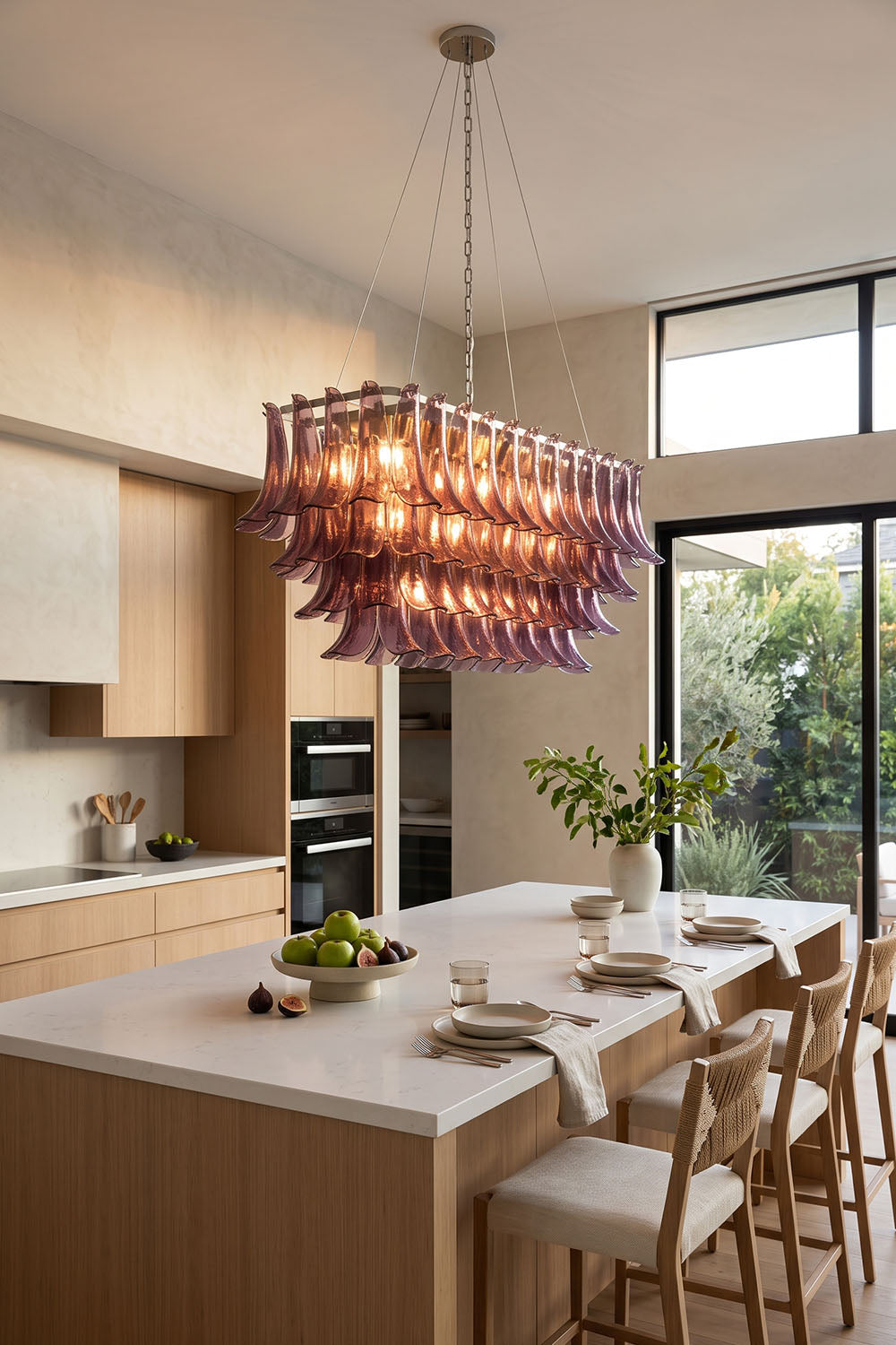 Ilvesse Amethyst Glass Petal Rectangular Chandelier | Amethyst Glass and Brass | Positioned over a kitchen island in a bright room with indoor plants | Samu Lamp