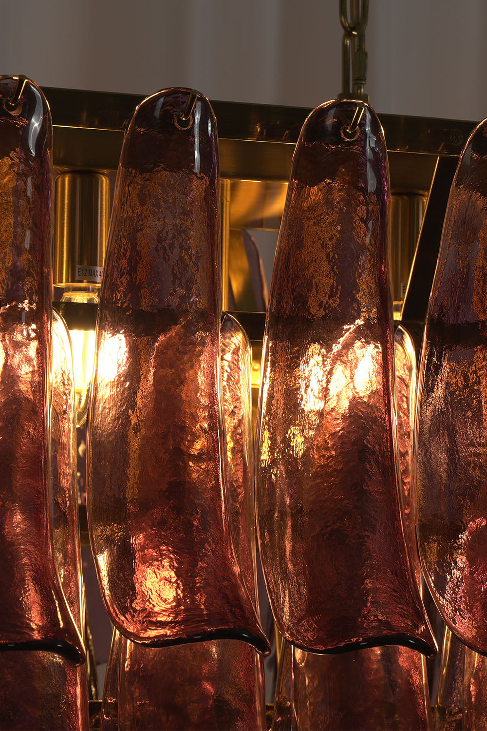 Ilvesse Amethyst Glass Petal Rectangular Chandelier | Amethyst Glass and Brass | Close-up view of glowing amethyst glass petals emitting warm light | Samu Lamp