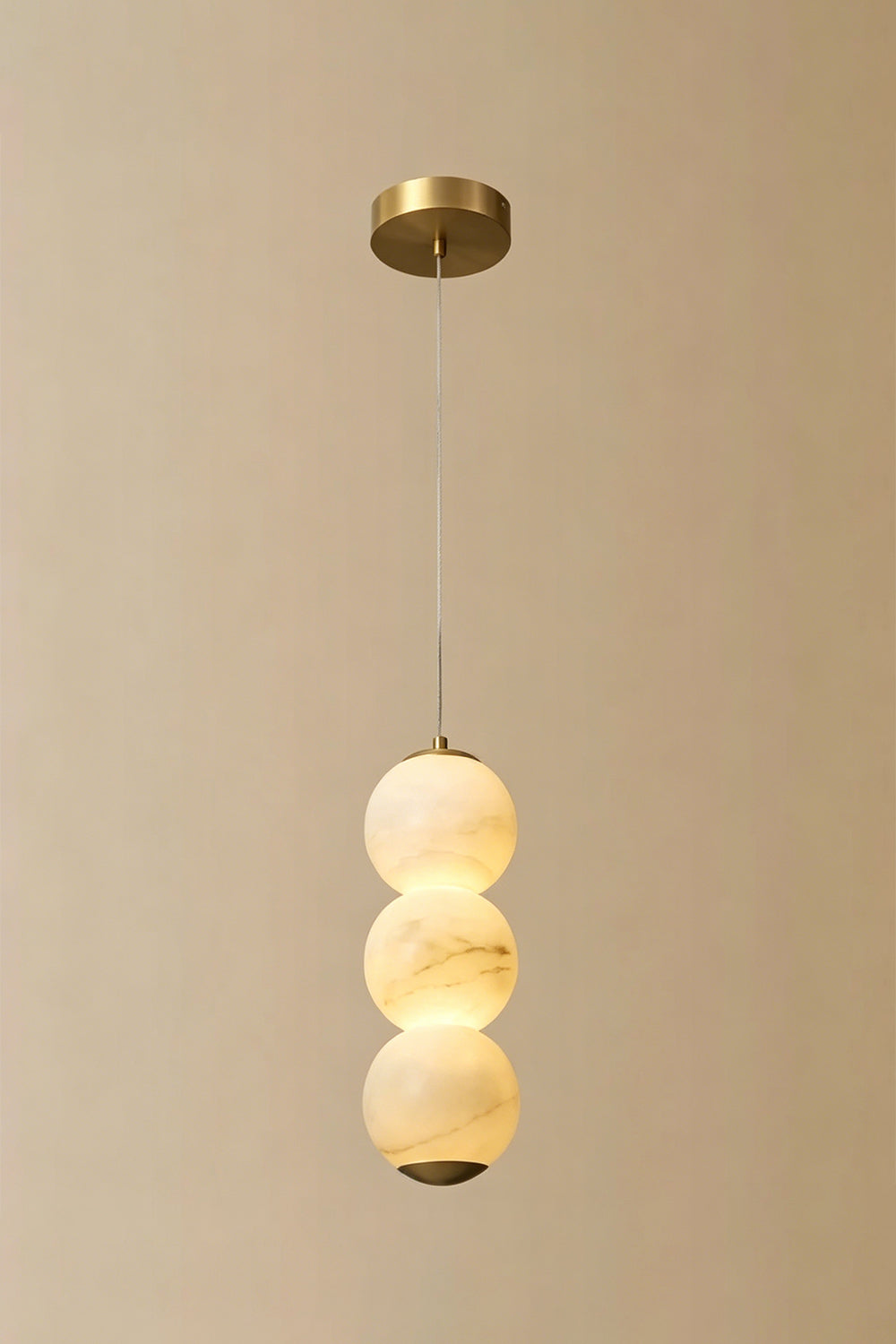 Imperial Epoch Alabaster Pendant Lamp | Metal, Alabaster | Full view of the three-sphere pendant variant against a beige background | Samu Lamp
