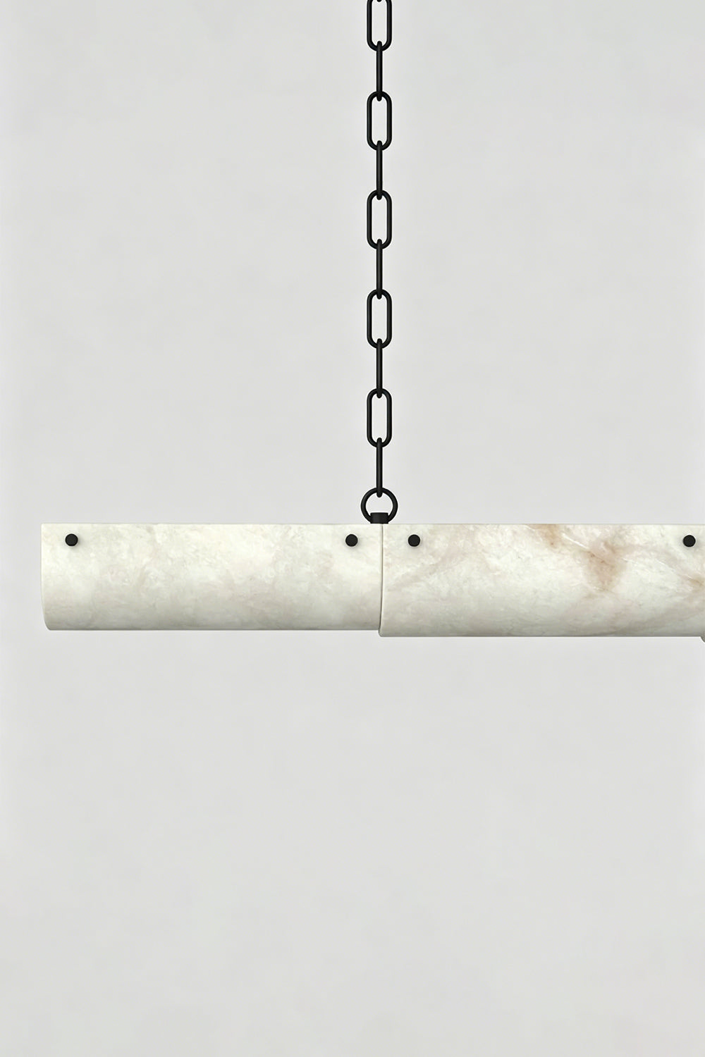 Imperial Strata Alabaster Linear Pendant Lamp | Alabaster, Metal | Close-up of the cylindrical alabaster joint and black metal chain link | Detail shot | Samu Lamp
