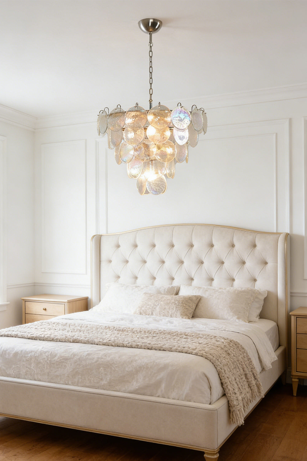Serene iridescent glass chandelier | Metal, Glass | Mounted in a master bedroom above a tufted bed | Samu Lamp