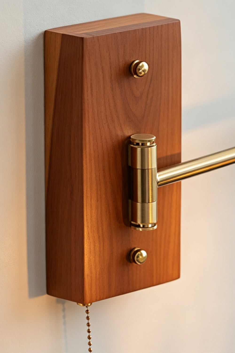 Iris Butterfly Stained Glass Wall Lamp | Stained Glass, Metal, Wood | Close-up focus on the rich grain of the rectangular warm-toned wood wall mount plate, a swivel brass rod joint, and the beaded metal pull chain switch | Detail shot | Samu Lamp