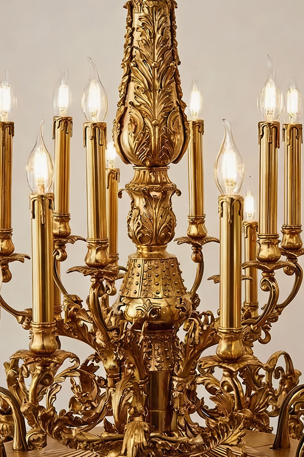 Detail of the Percival Grand Brass Candelabra Chandelier showcasing intricate design and glowing light bulbs.