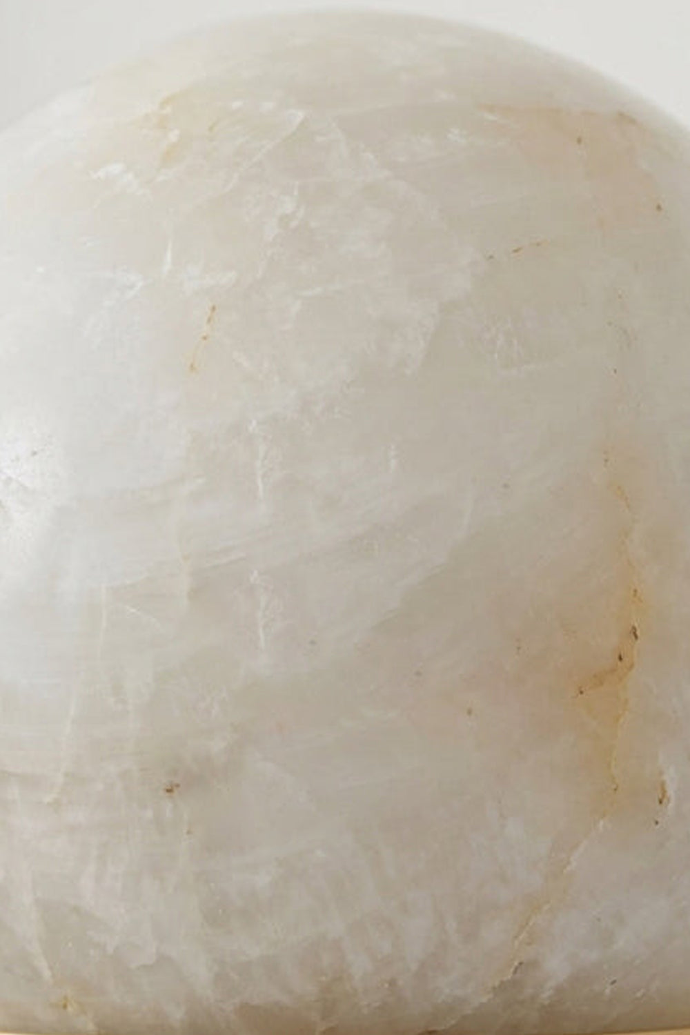 Isolde Alabaster Orb Wall Sconce | Natural Alabaster and Aged Brass | Macro texture close-up focusing on the natural organic veining of the alabaster stone orb | Samu Lamp
