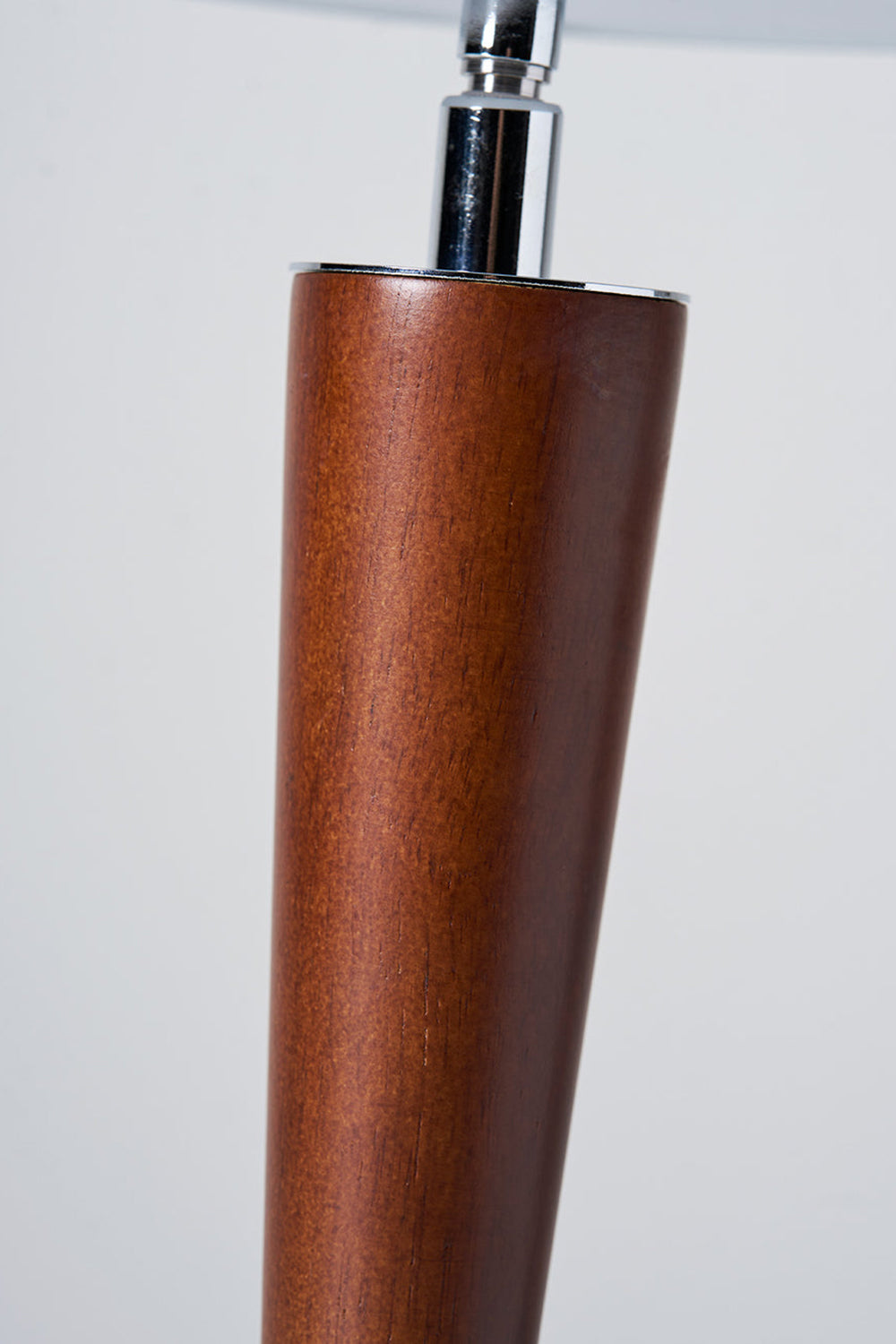 Isolde Domed Walnut Table Lamp | Walnut Stem Detail | Macro close-up shot focusing on the smooth organic grain of the tapered walnut wood body and the chrome neck connector | Detail shot | Samu Lamp