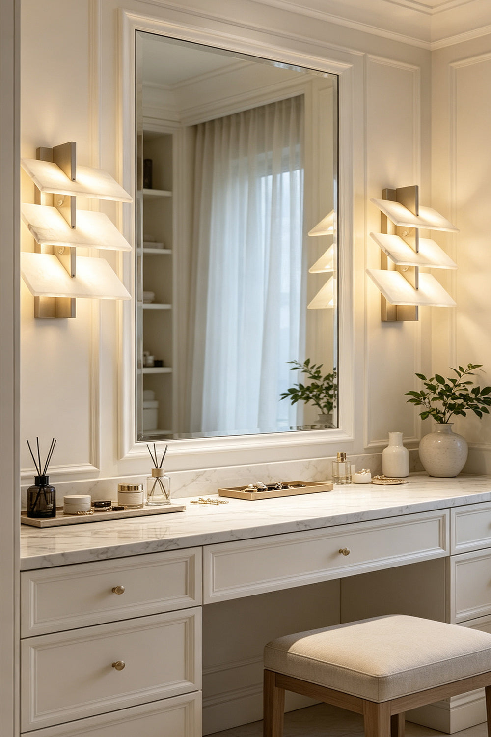 Isolde Tiered Alabaster Slab Wall Sconce illuminating a vanity area with mirror and soft lighting.