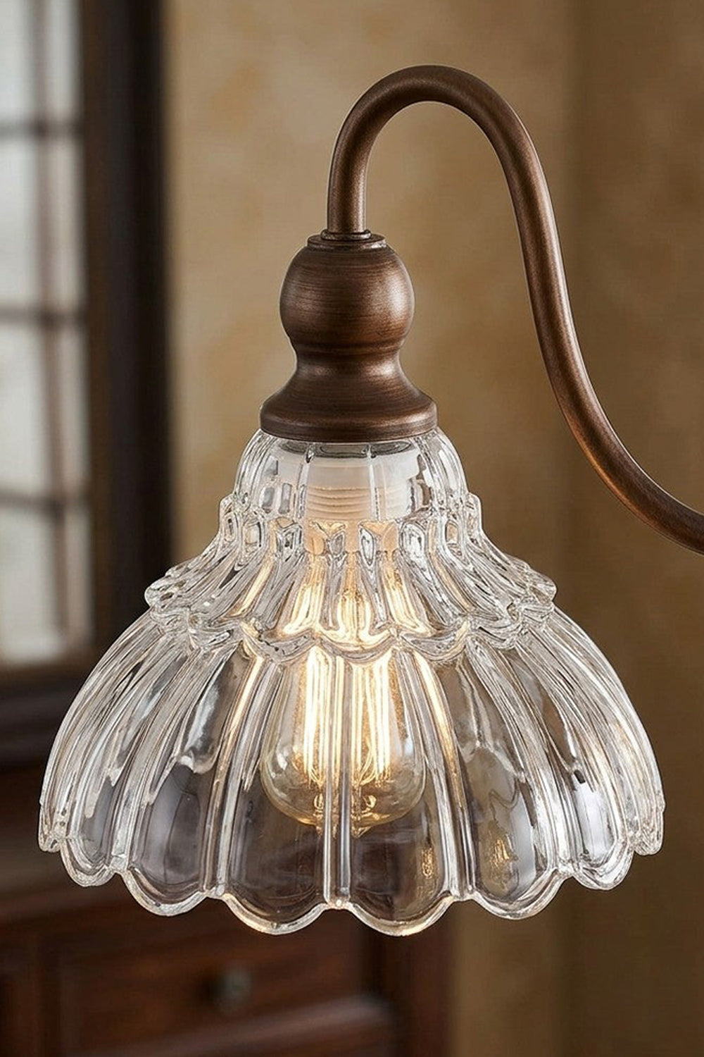 Isolde Vintage Glass Long Chandelier | Scalloped Shade Close-up | Detailed macro shot of an individual clear ruffled glass flower-like shade attached to the dark bronze curved arm hardware | Detail shot | Samu Lamp