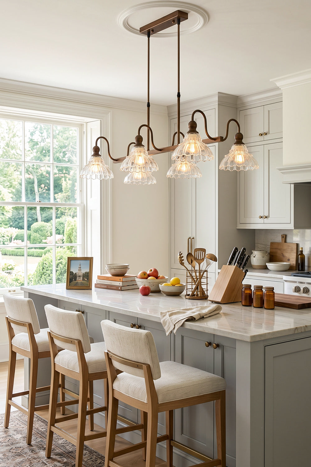 Isolde Vintage Glass Long Chandelier | Kitchen Island Lighting | Hanging as a timeless centerpiece over a modern white kitchen island breakfast bar paired with elegant counter stools | Samu Lamp