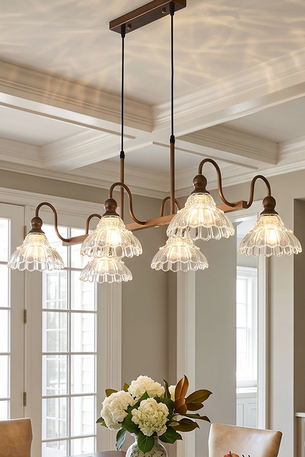 Isolde Vintage Glass Long Chandelier | Ambient Room Light | Staged ceiling view of the fully illuminated linear glass fixture casting a warm golden glow in an upscale classical interior | Samu Lamp