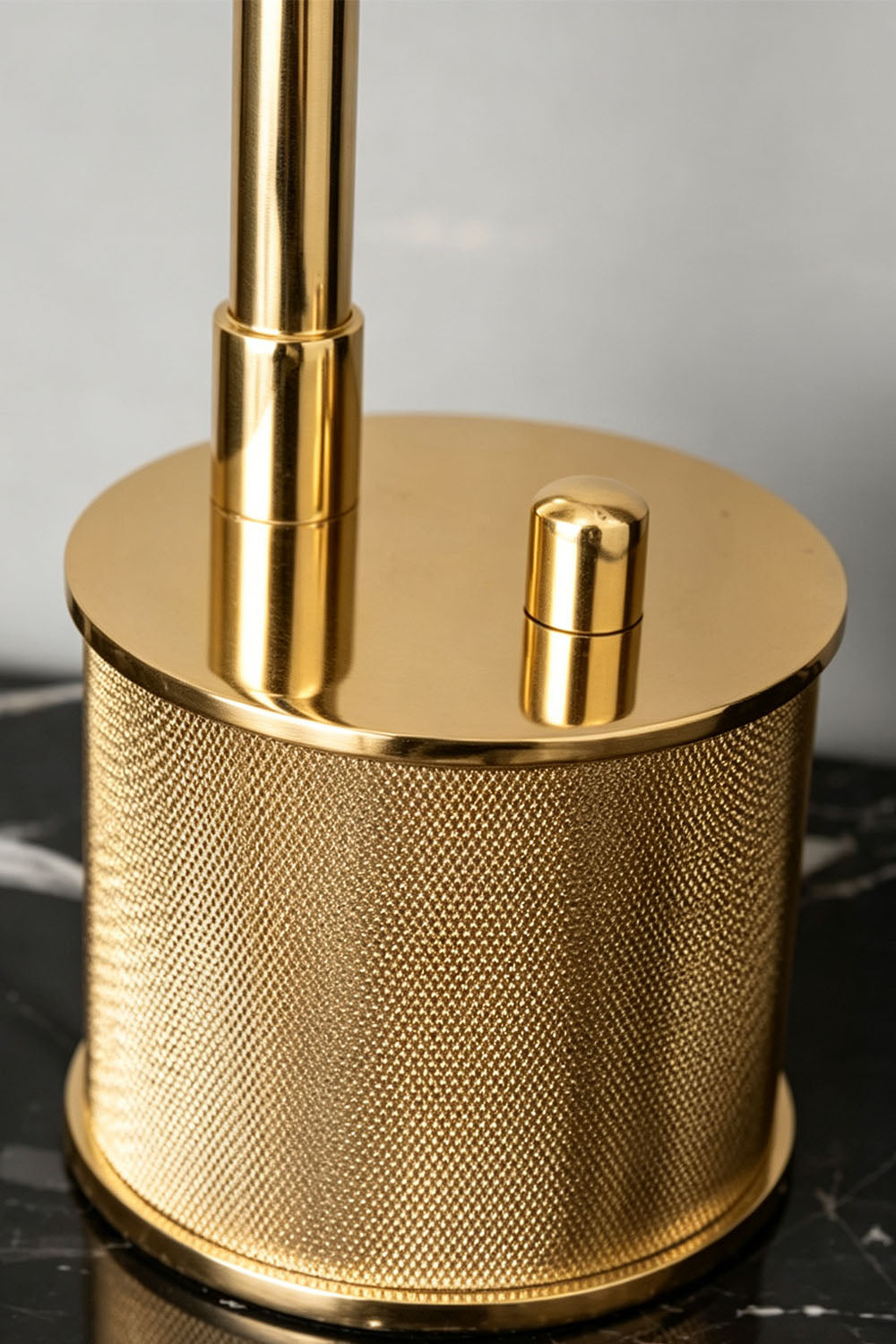 Ivor Knurled Brass Task Table Lamp | Knurled Brass and Metal | Macro close-up of the knurled textured brass cylindrical base and switch | Samu Lamp