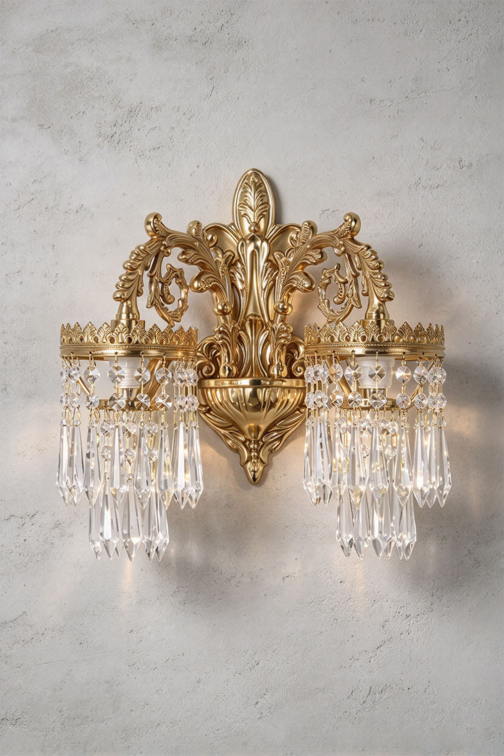 Josseline Brass Crystal Crown Wall Lamp | Cut Crystal and Brass | Front view of the 2-light double-arm sconce variant on a textured wall | Samu Lamp