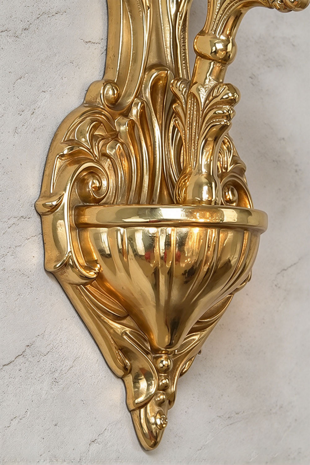 Josseline Brass Crystal Crown Wall Lamp | Cut Crystal and Brass | Macro detail of the intricately carved brass backplate bottom finial | Samu Lamp