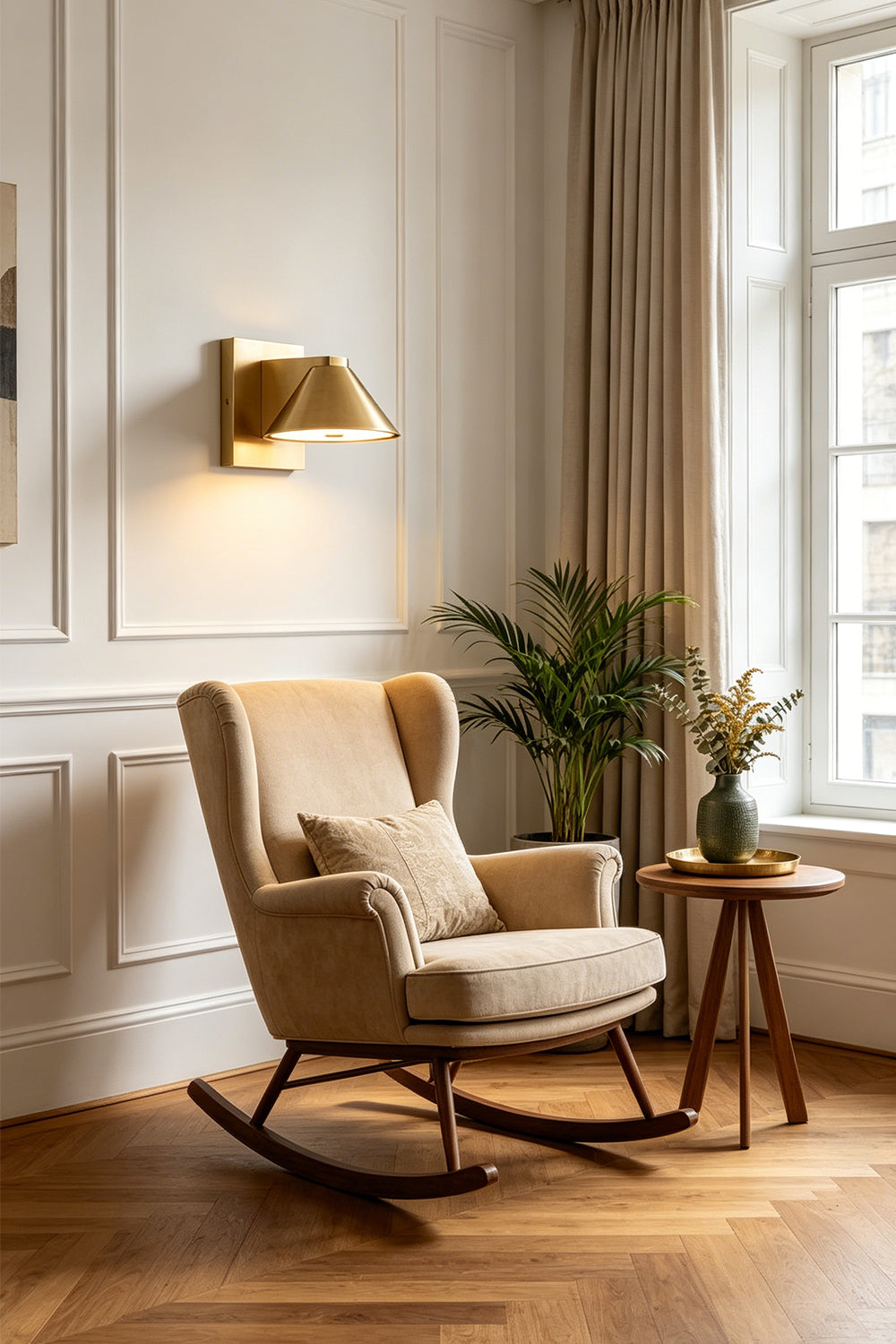 Kaelen Brass Cone Wall Sconce | Reading Nook Lighting | Positioned elegantly to illuminate a cozy corner featuring a traditional beige wingback rocking chair and wooden side table | Samu Lamp