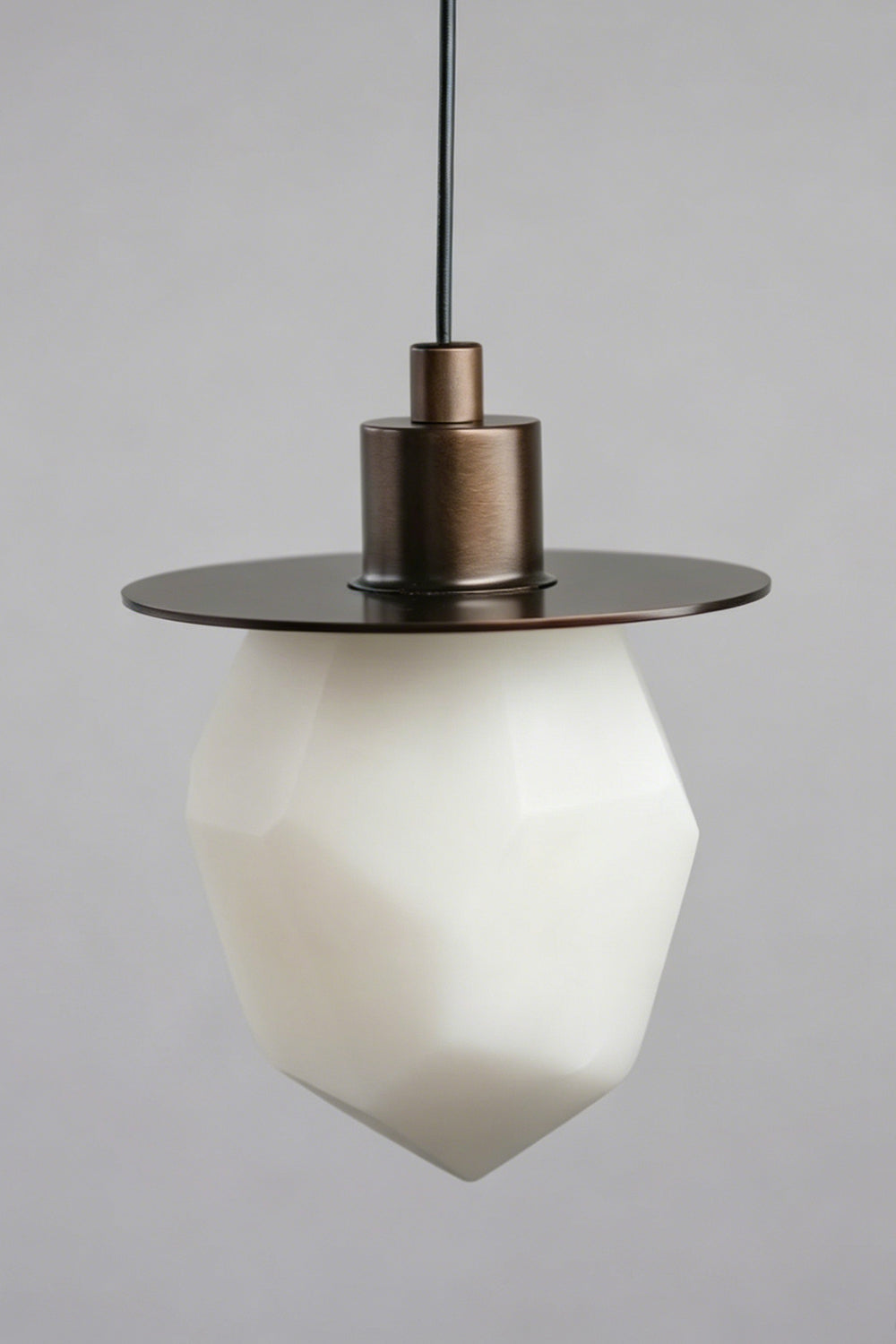 Kaelen Faceted Alabaster Pendant Light | Alabaster, Metal | Unlit studio view of the geometric white natural stone pendant showcasing its clean faceted textures against a grey wall | Samu Lamp