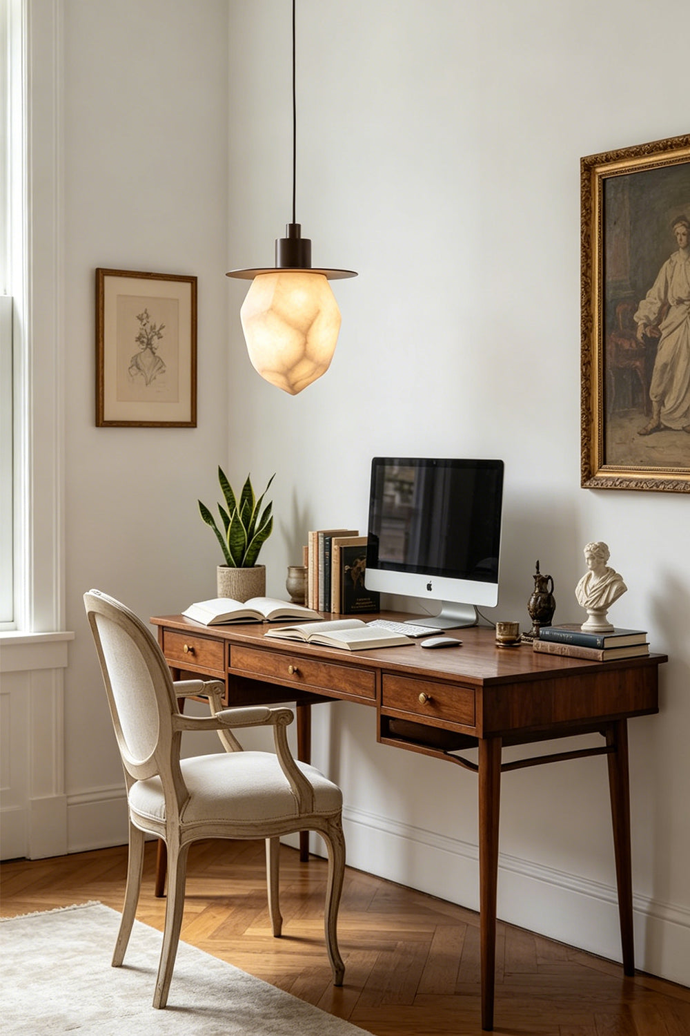 Kaelen Faceted Alabaster Pendant Light | Alabaster, Metal | Providing warm ambient illumination in a modern home office above a classic dark wood writing desk with a chair | Samu Lamp