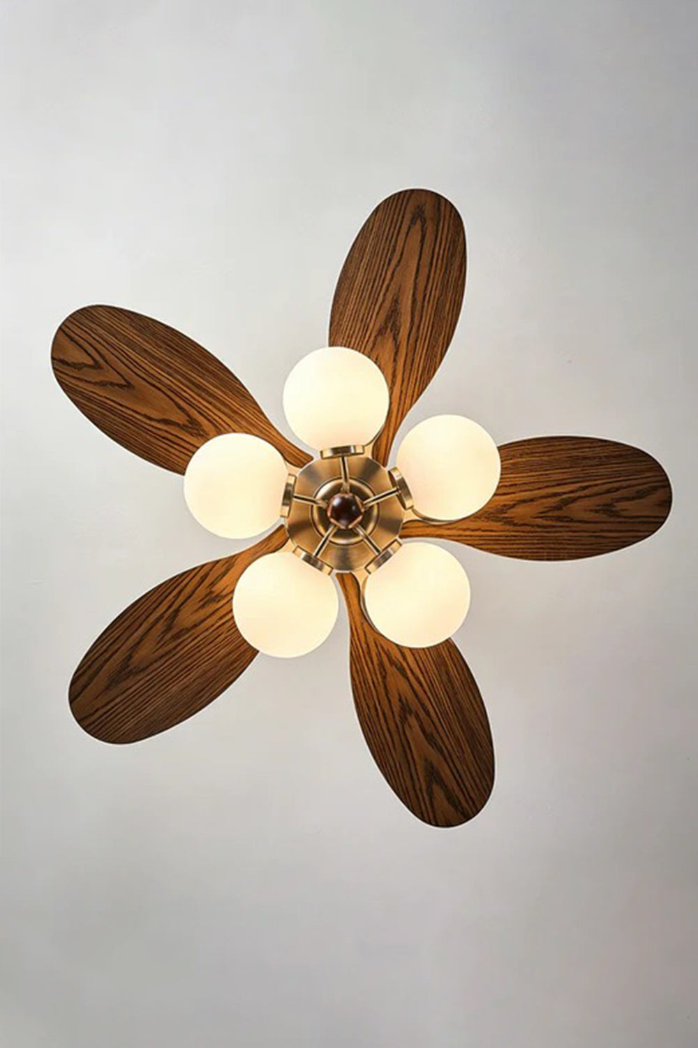 Keller Wooden Ceiling Fan Light | Wood, Glass, Metal | Direct bottom-up view showcasing the symmetrical arrangement of the five dark wood blades and five glowing white glass globes | Detail shot | Samu Lamp