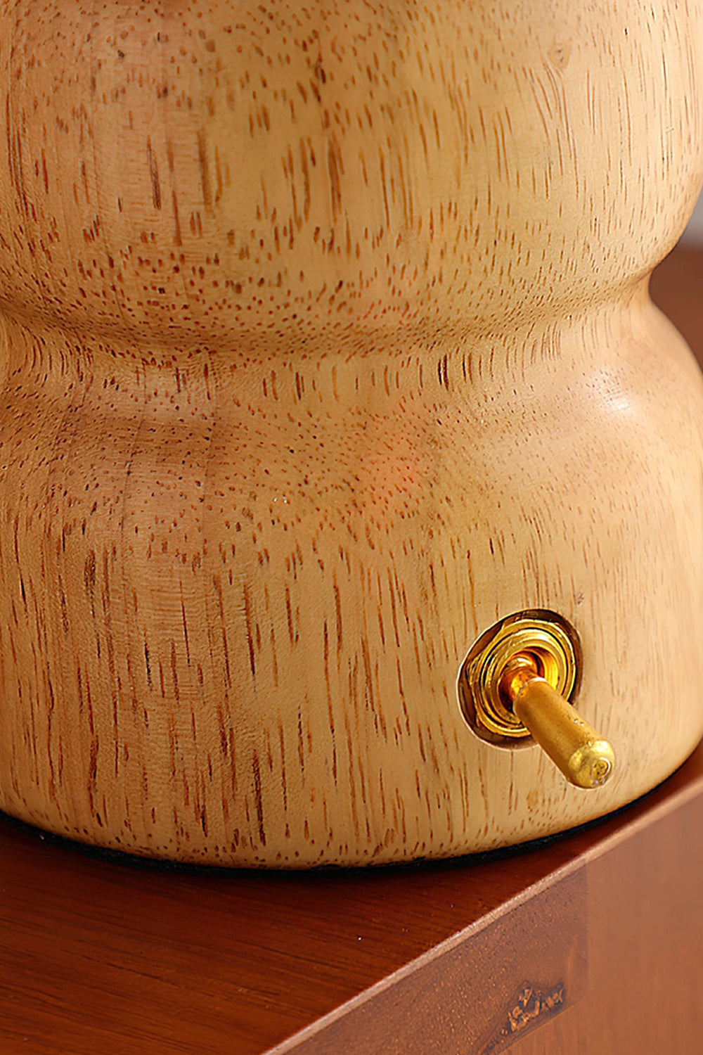 Kira Sculpted Mushroom Table Lamp | Wood, Glass | Close-up focus on the lighter oak wood variant base featuring a polished gold toggle switch | Detail shot | Samu Lamp