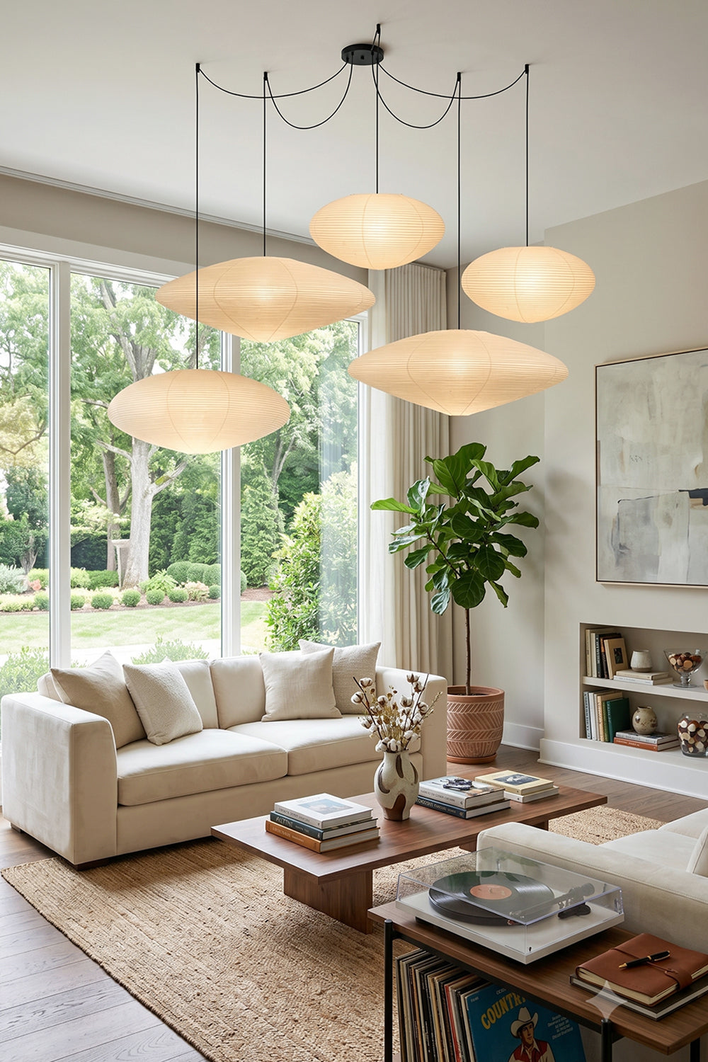 Komorebi Mulberry Paper Pendant Light | Paper, Bamboo | A cascading cluster of four paper pendants enhancing a serene minimalist Japandi living room with a cream sofa | Samu Lamp