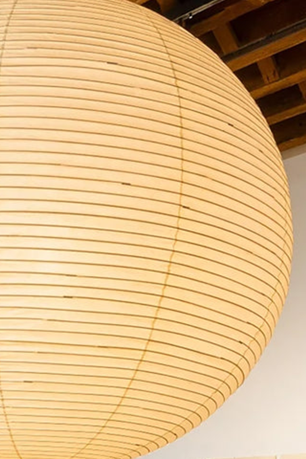 Komorebi Mulberry Paper Pendant Light | Paper, Bamboo | Close-up structural view of an unlit cream mulberry paper lantern highlighting the intricate horizontal bamboo ribs | Detail shot | Samu Lamp