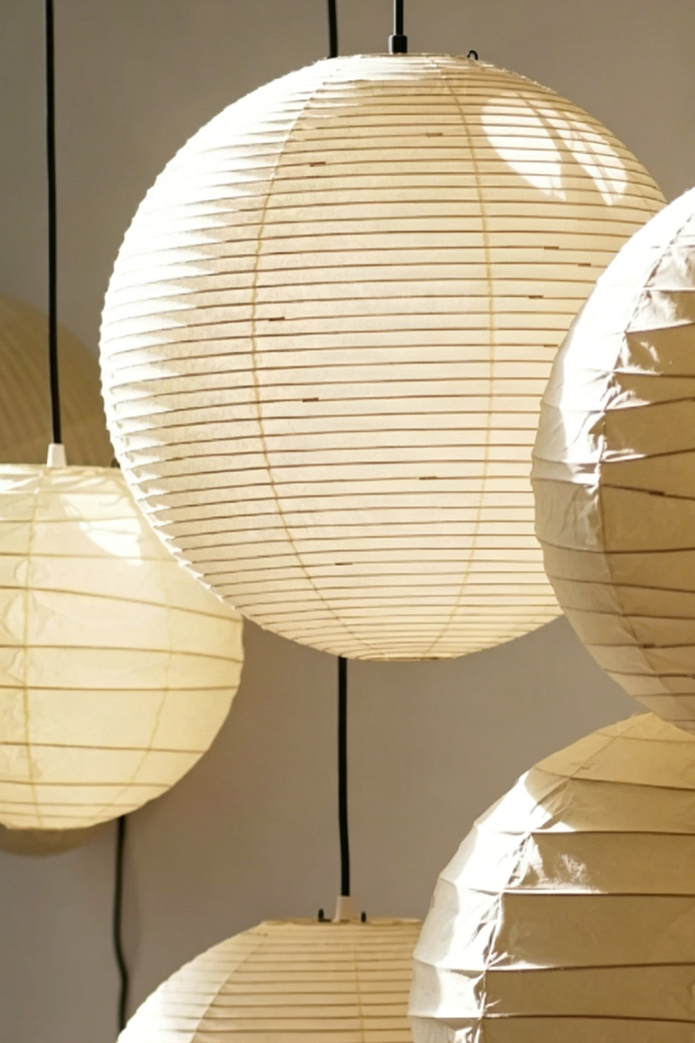 Komorebi Mulberry Paper Pendant Light | Paper, Bamboo | Close-up focus on overlapping illuminated mulberry paper shades showcasing the fine bamboo ribbing and texture | Detail shot | Samu Lamp