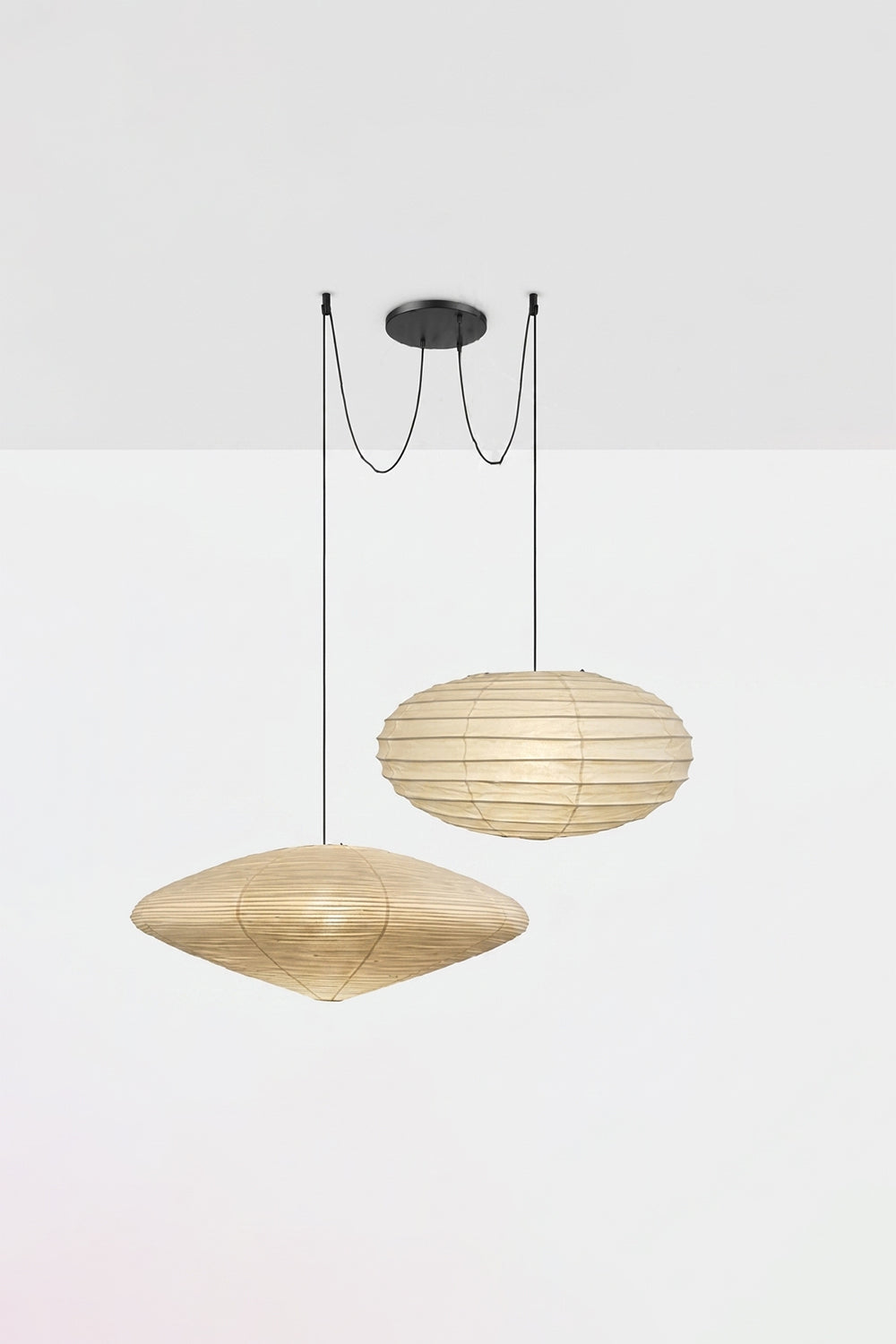 Komorebi Mulberry Paper Pendant Light | Paper, Bamboo | Studio view of a lit 3-light combination variant with two flat saucer shades and one sphere casting a warm glow | Samu Lamp