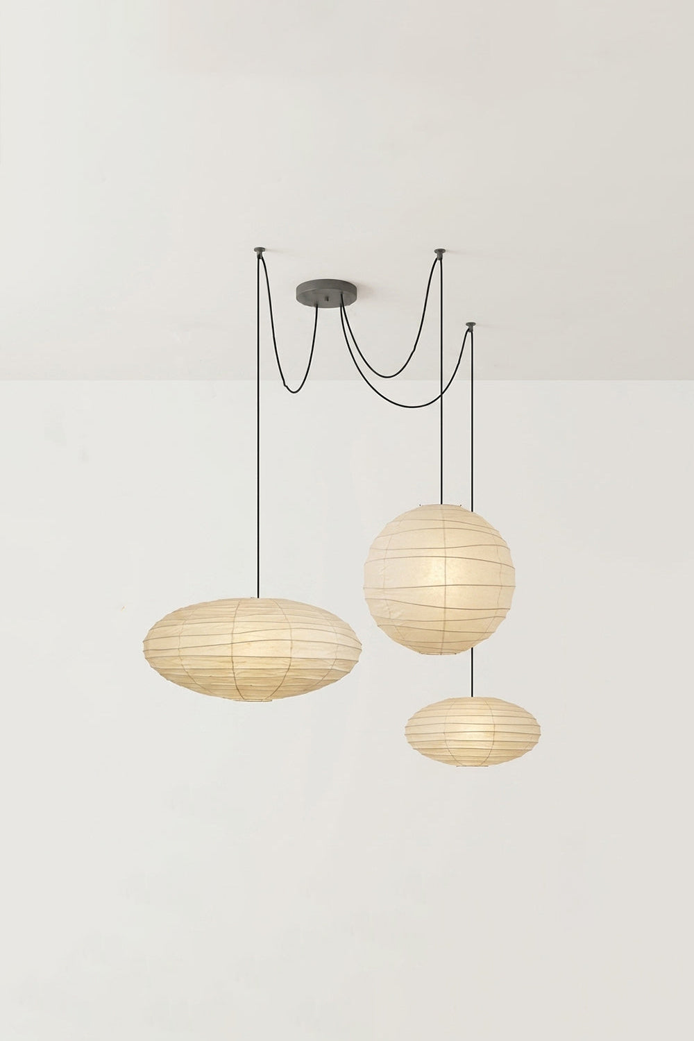 Komorebi Mulberry Paper Pendant Light | Paper, Bamboo | Studio view of an unlit 3-light multi-pendant arrangement showing two wide saucers and a central sphere | Samu Lamp