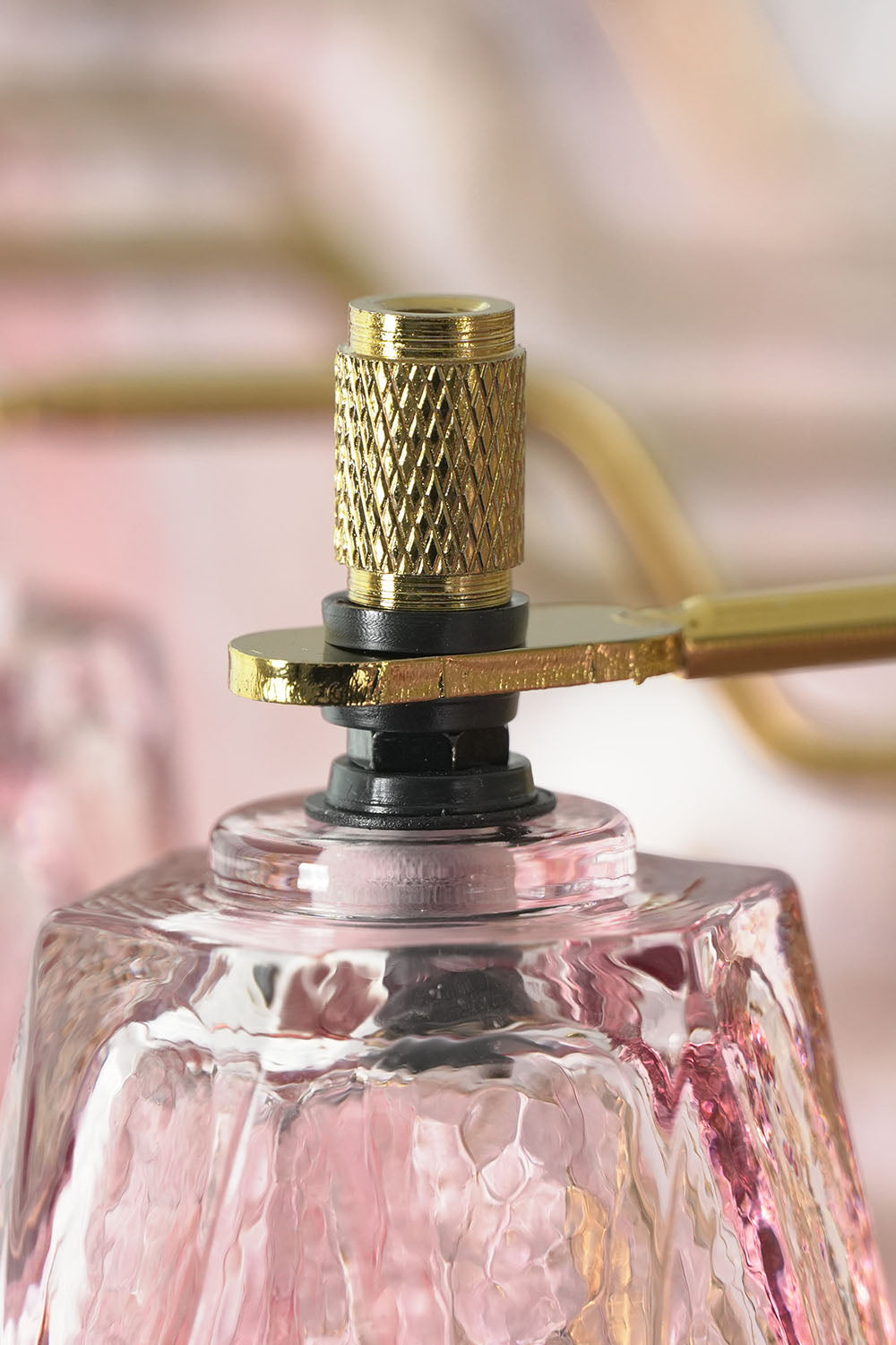 Lauragne Pink Faceted Glass Cascade Chandelier | Pink Faceted Glass and Brass | Macro close-up shot of top brass finial hardware on a pink glass prism | Samu Lamp