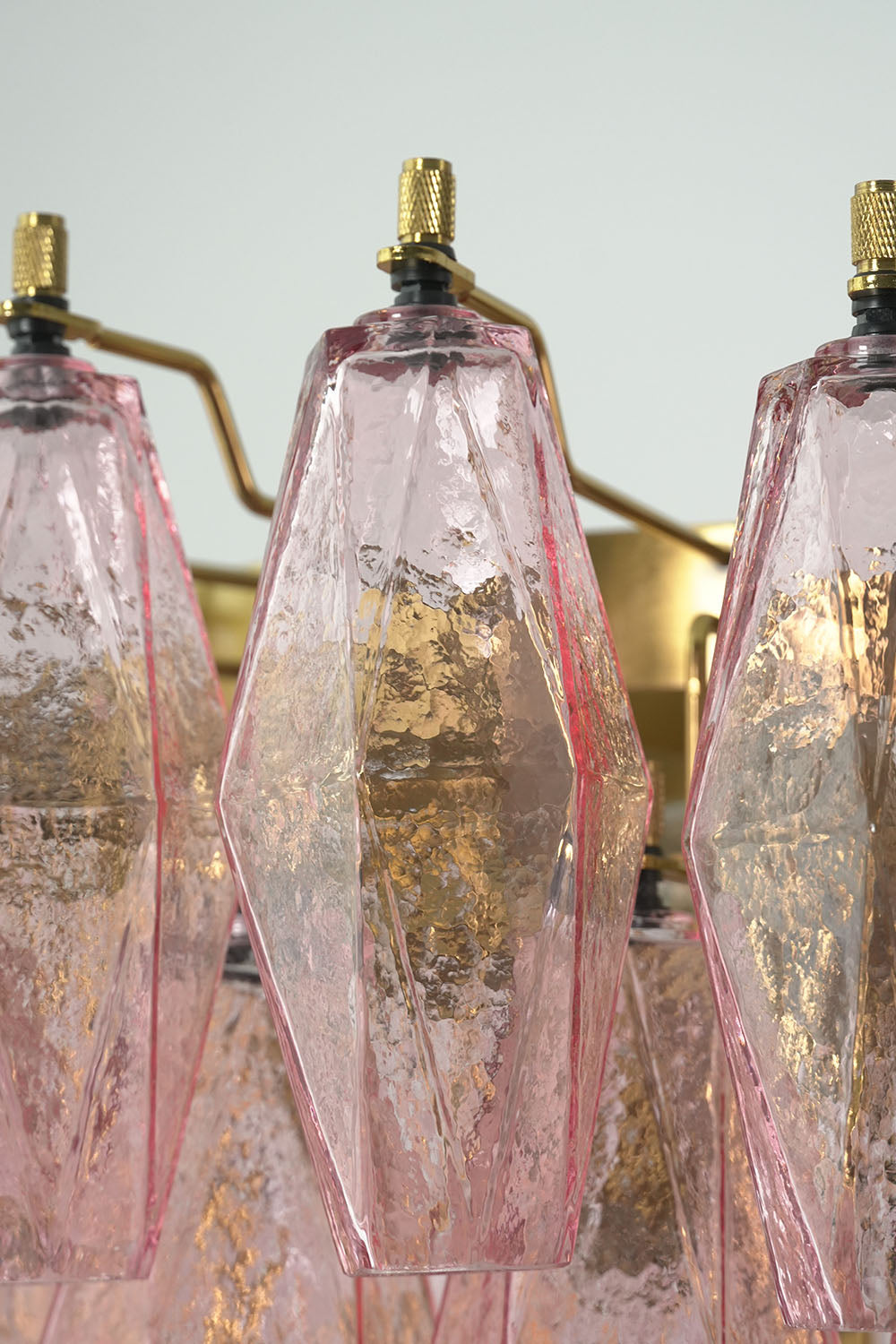 Lauragne Pink Faceted Glass Cascade Chandelier | Pink Faceted Glass and Brass | Close-up detail of faceted pink glass prisms mounted on brass frame | Samu Lamp