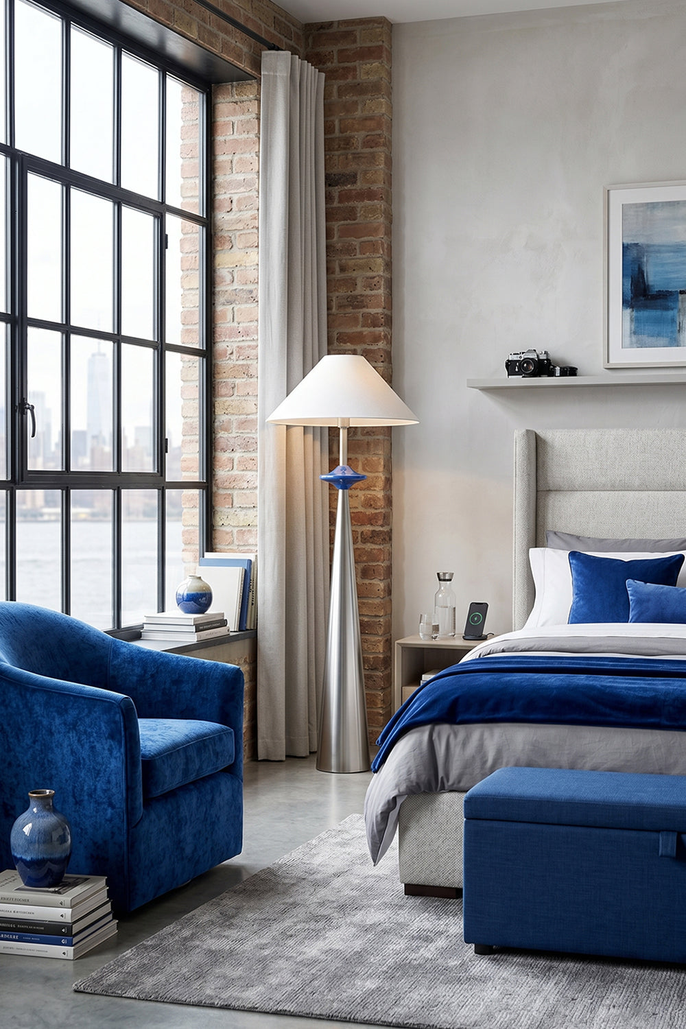 Lazuro Postmodern Cone Floor Light | Metal, Fabric | Standing as an elegant reading lamp in an industrial loft bedroom corner next to a plush blue velvet armchair and a platform bed | Samu Lamp