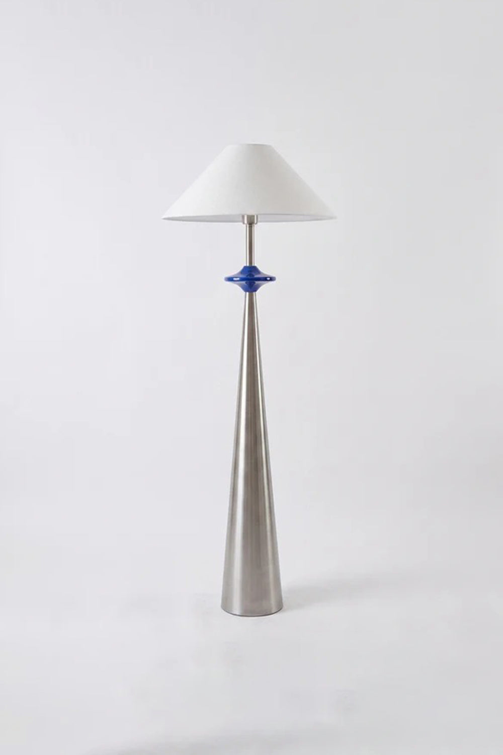 Lazuro Postmodern Cone Floor Light | Metal, Fabric | Studio full-length view of the unlit tapered silver floor fixture showcasing its sculptural silhouette against a white backdrop | Samu Lamp