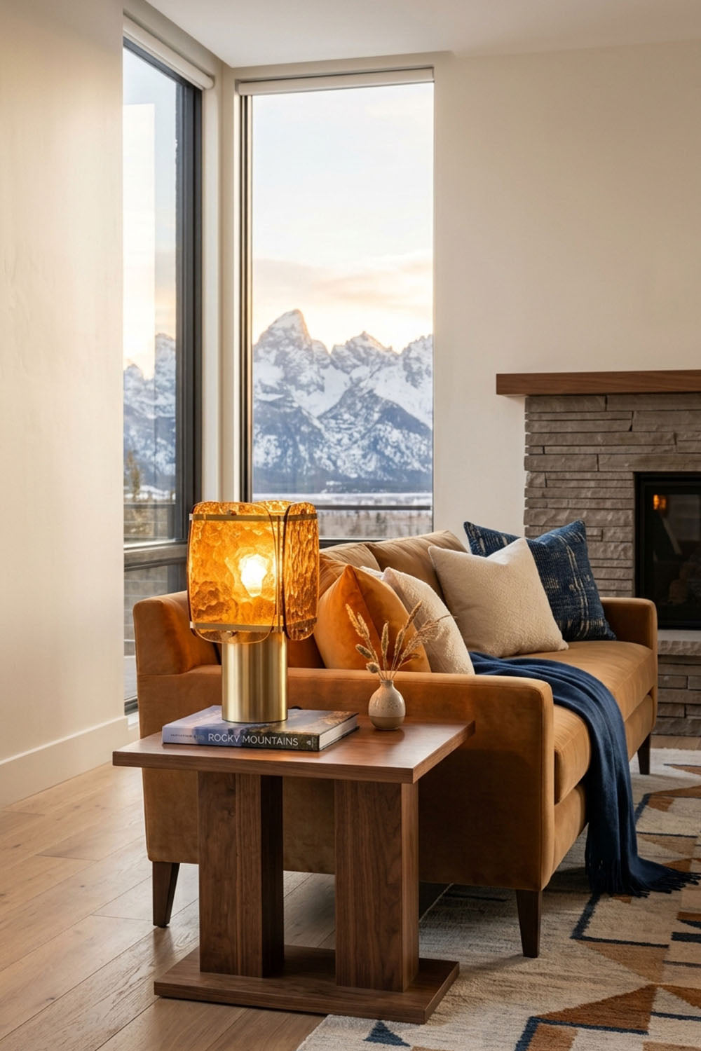 Lesquin Hammered Amber Glass Table Lamp | Hammered Amber Glass and Brass | Styled on a wooden side table beside a tan sofa facing mountain landscape windows | Samu Lamp