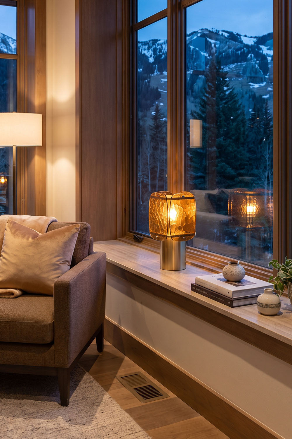 Lesquin Hammered Amber Glass Table Lamp | Hammered Amber Glass and Brass | Placed on a wooden window sill ledge overlooking snowy trees | Samu Lamp