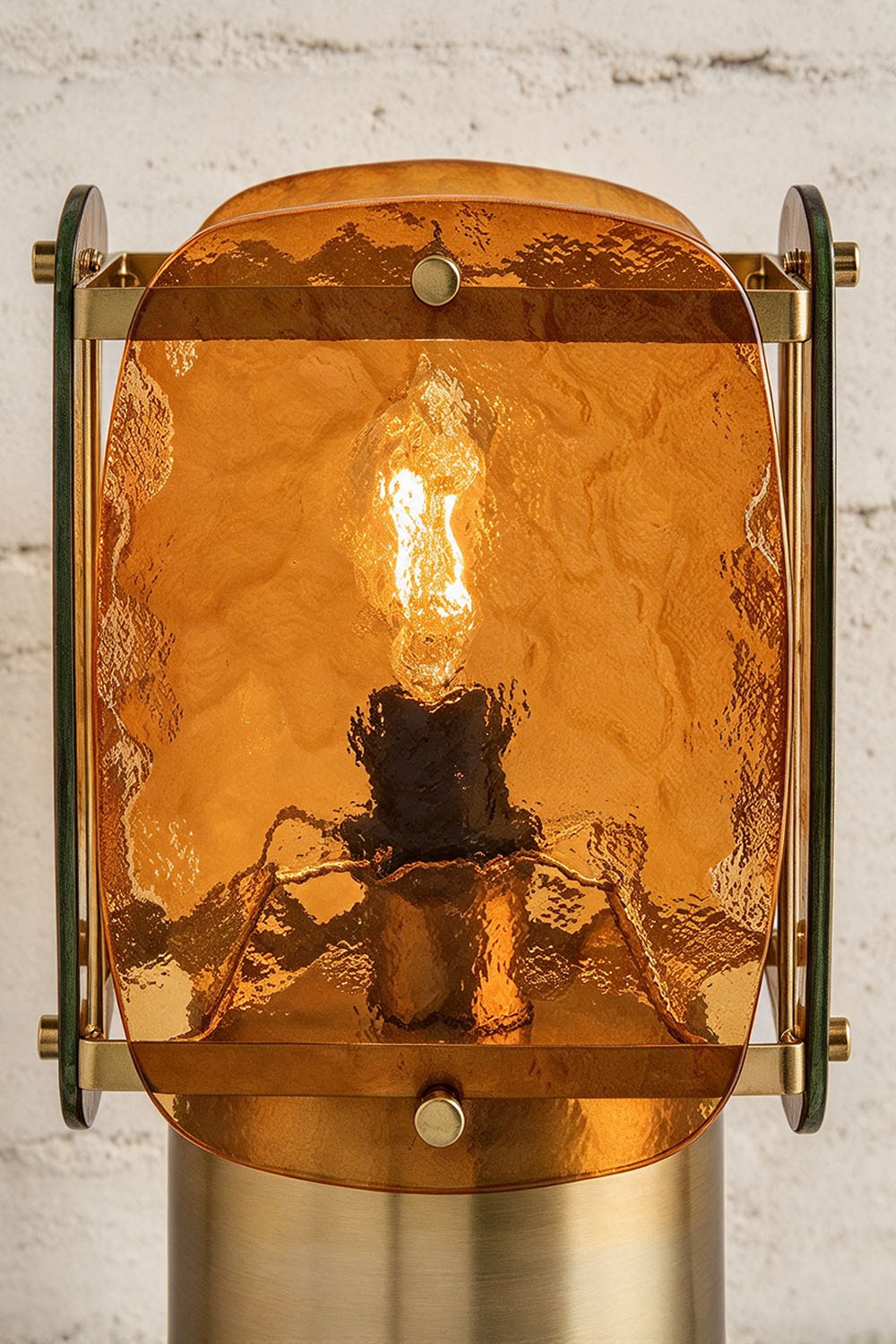Lesquin Hammered Amber Glass Table Lamp | Hammered Amber Glass and Brass | Front close-up view showing the illuminated bulb through hammered amber glass panels | Samu Lamp