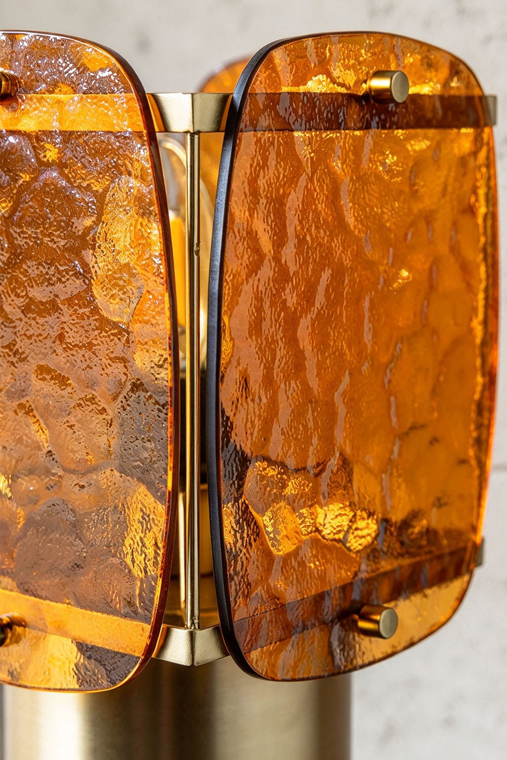 Lesquin Hammered Amber Glass Table Lamp | Hammered Amber Glass and Brass | Angled close-up detail of the amber glass panels secured by brass brackets | Samu Lamp