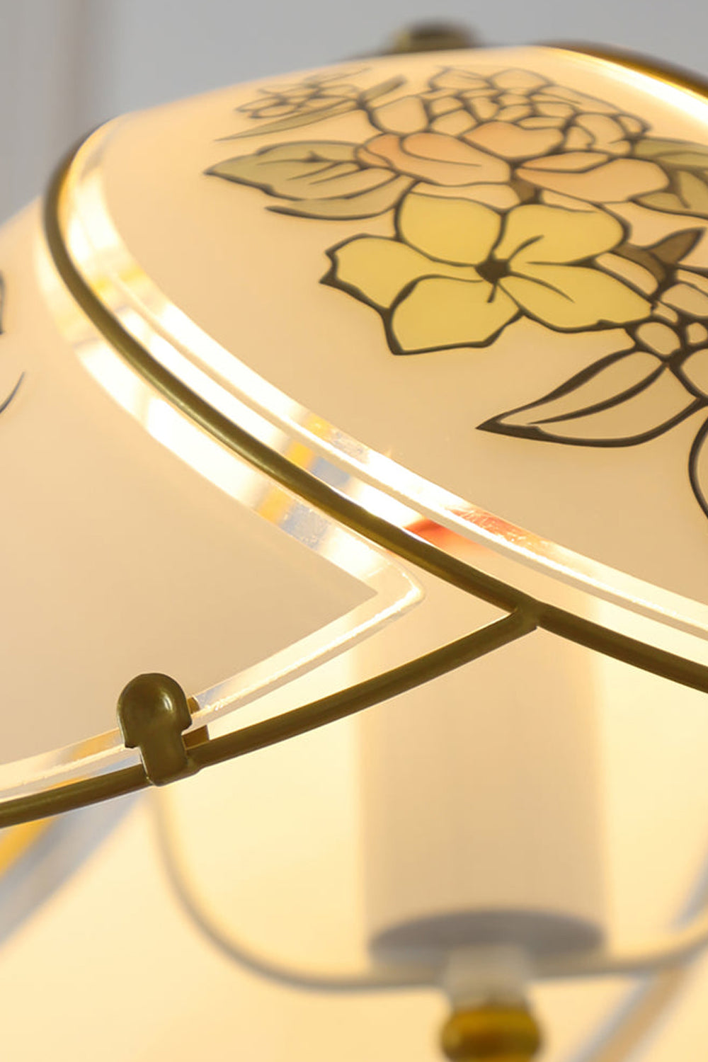 Lillian Retro Floral Pendant Lamp | Glass, Metal | Close-up focus on the illuminated white glass shade highlighting the delicate warm yellow floral painted line details | Detail shot | Samu Lamp
