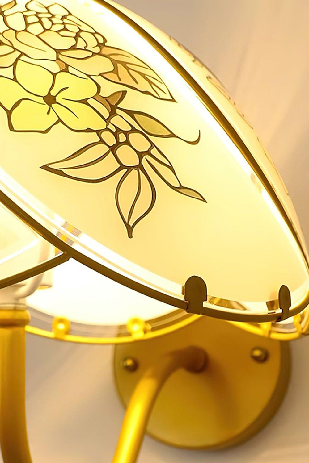 Lillian Retro Floral Wall Lamp | Glass, Metal | Upward close-up perspective of the lit floral glass panel and its decorative golden metal frame | Detail shot | Samu Lamp