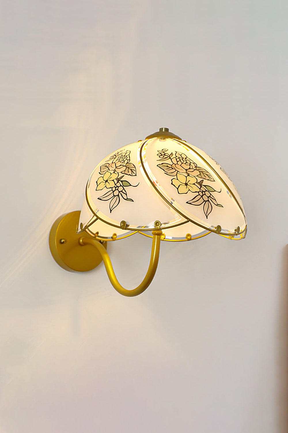 Lillian Retro Floral Wall Lamp | Glass, Metal | Frontal view of the fully lit retro floral sconce casting a warm golden backlight halo on a neutral wall | Samu Lamp